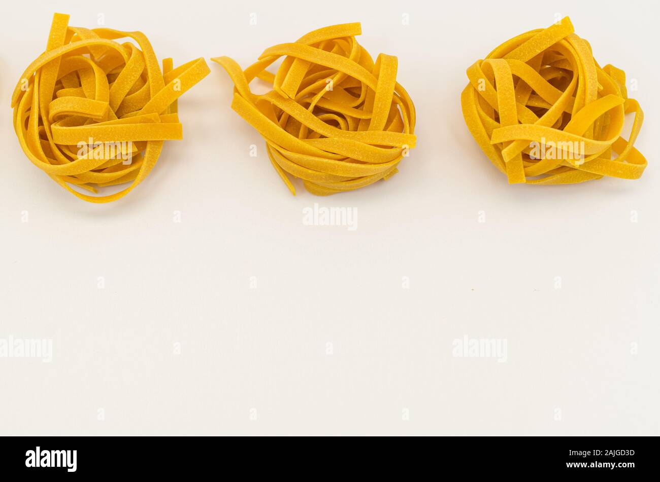 italian tagliatelle pasta nests on a white background natural food