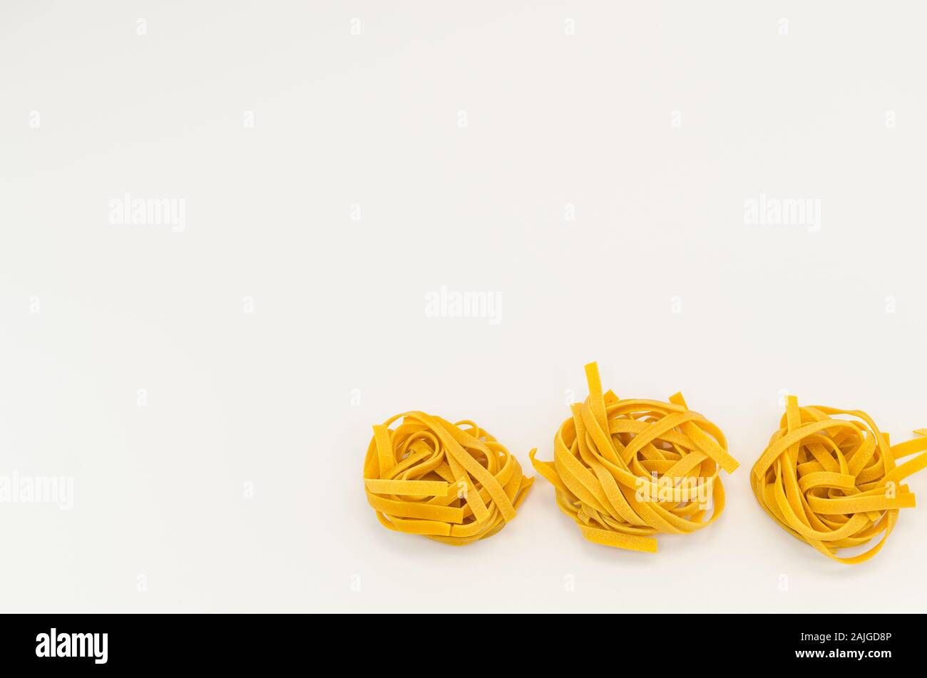 italian tagliatelle pasta nests on a white background natural food
