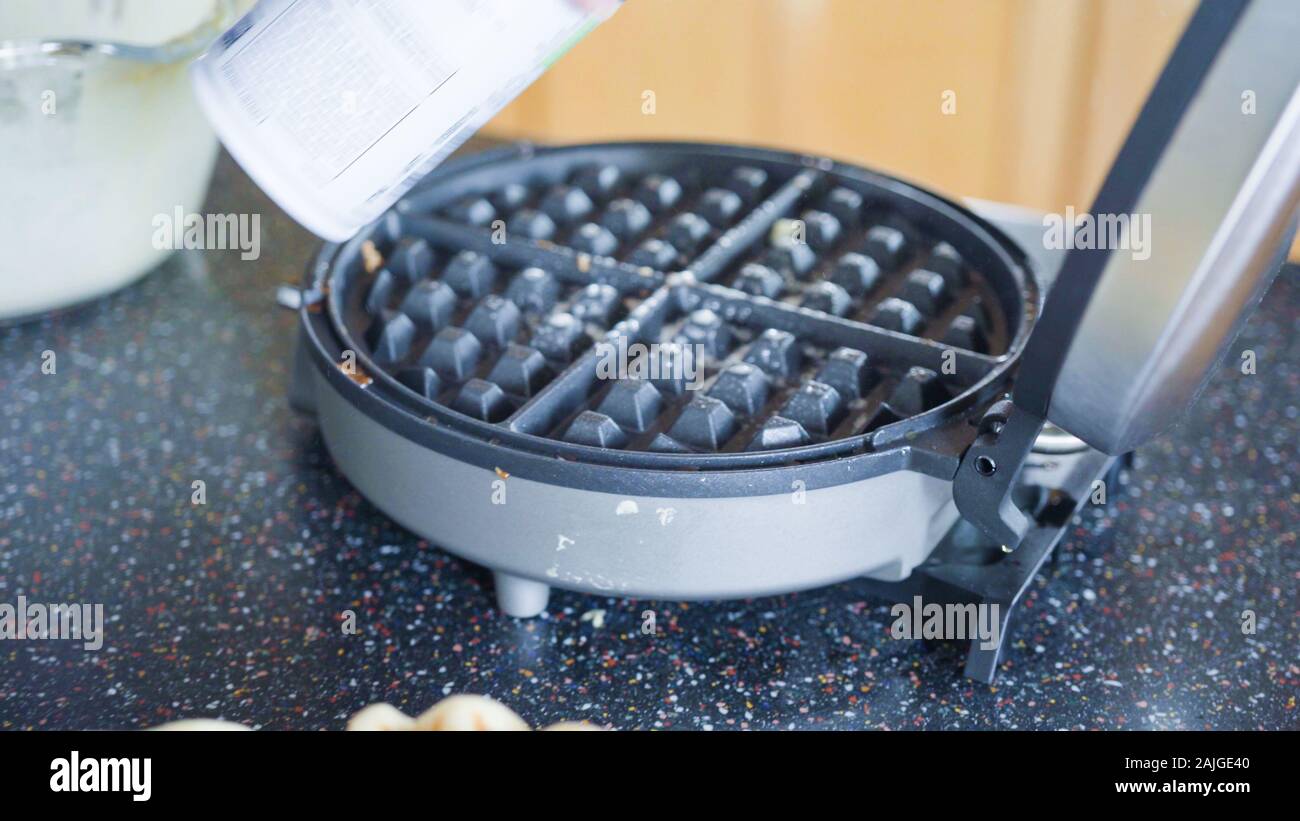 Making homemade waffles in an electric waffle maker Stock Photo Alamy