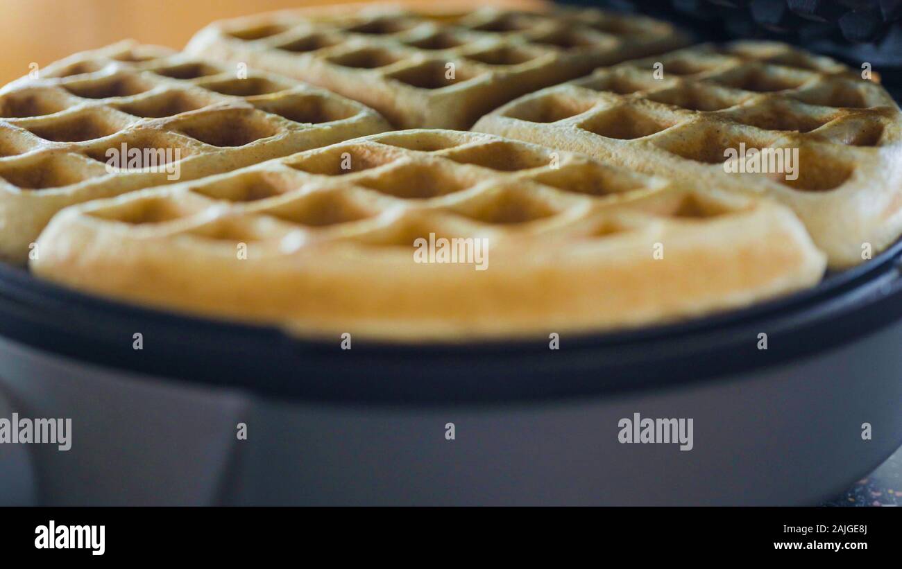 Making homemade waffles in an electric waffle maker Stock Photo Alamy