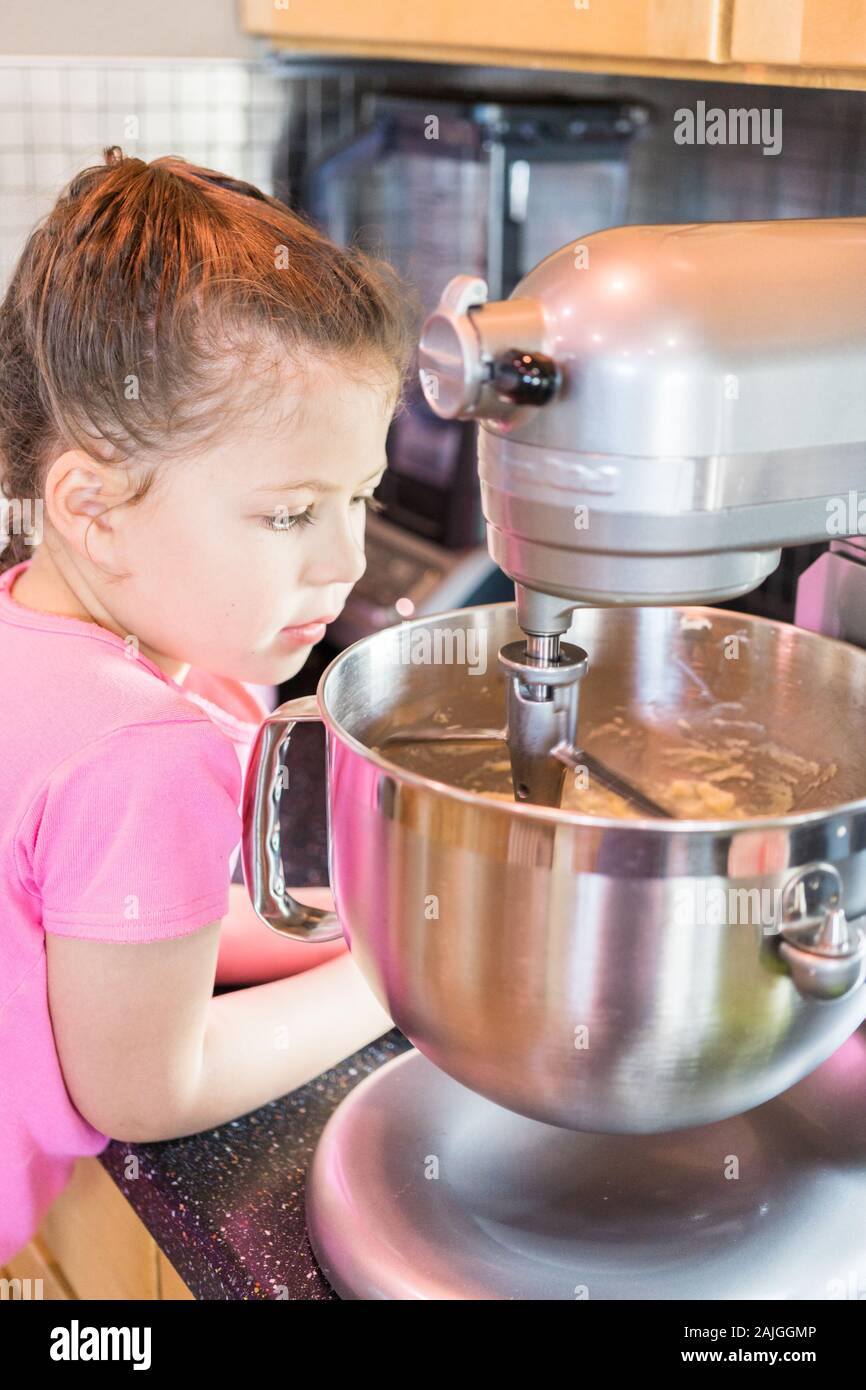 Little girl helping bake mini pound cakes in silicone molds shaped as on owls Stock Photo Alamy