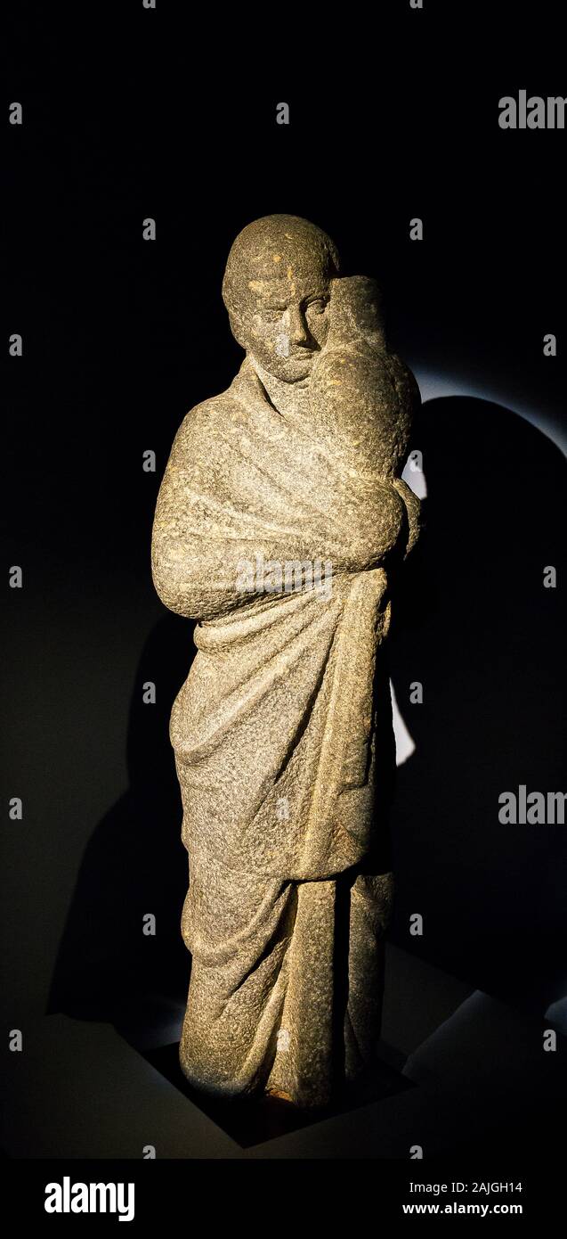 Opening visit of the exhibition “Osiris, Egypt's Sunken Mysteries”. A statue of a man, probably an Osiris priest, carrying a canopic jar. Stock Photo