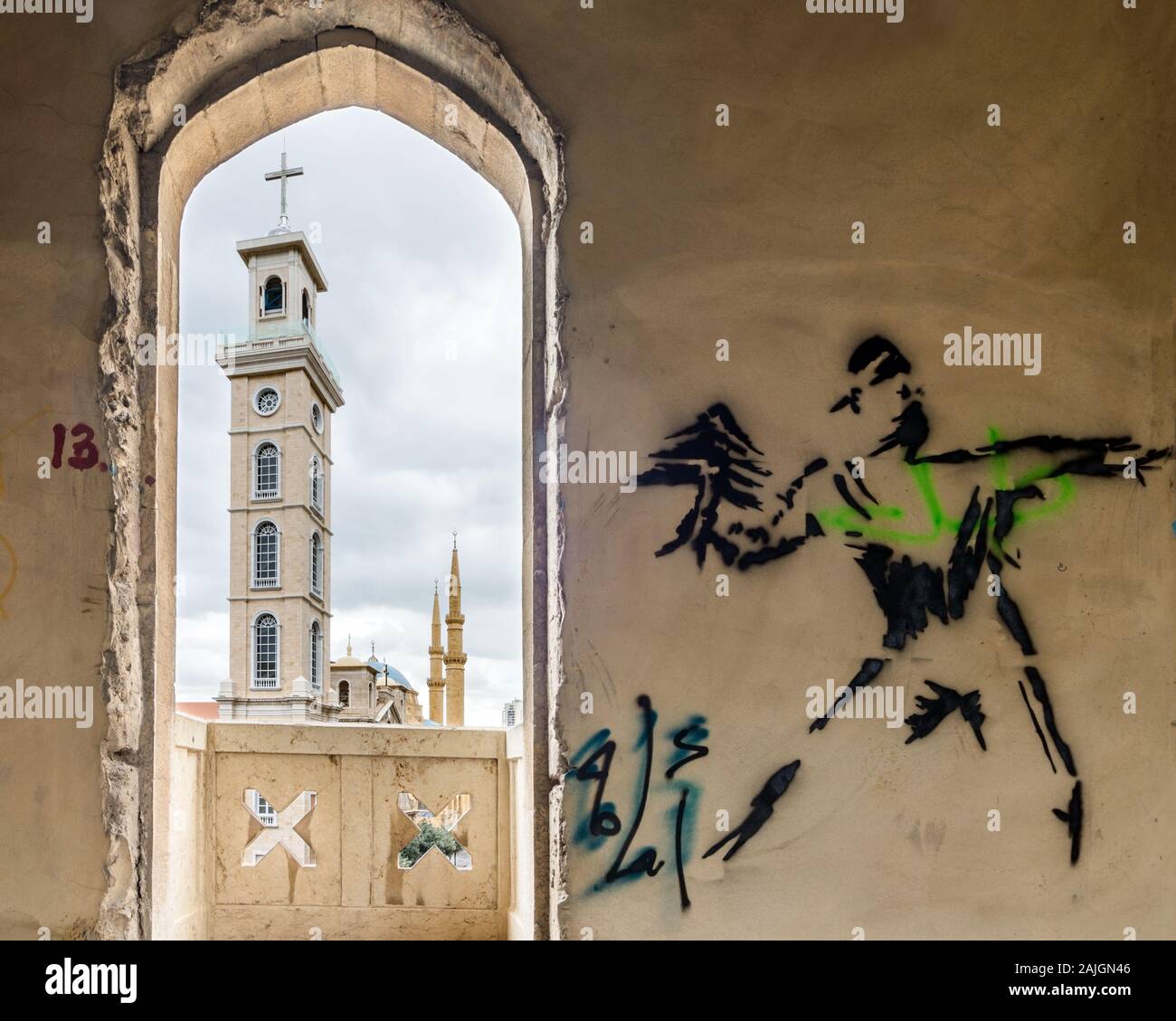 Graffiti on the walls of Grand Theater of Beirut or 'Le Grand Theatre des Milles et Une Nuits', with St. Georges cathedral and Al-Amin mosque, Beirut Stock Photo