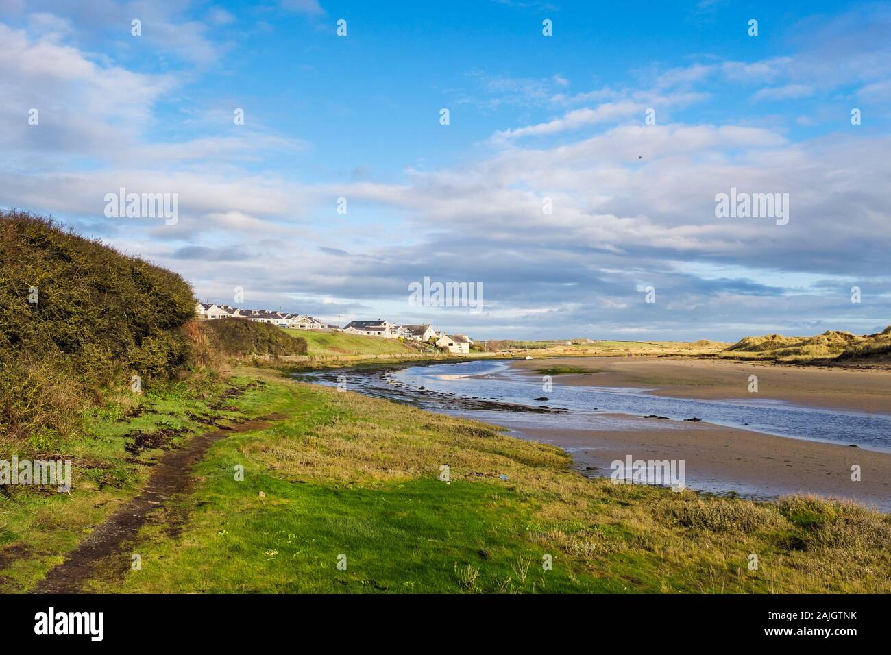 Looking inland along Isle of Anglesey coastal footpath beside Afon Ffraw river at low tide. Aberffraw, Anglesey, north Wales, UK, Britain, Europe Stock Photo