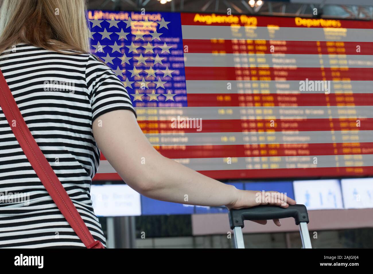 Woman looks at the scoreboard at the airport. Select a country USA for travel or migration. Stock Photo