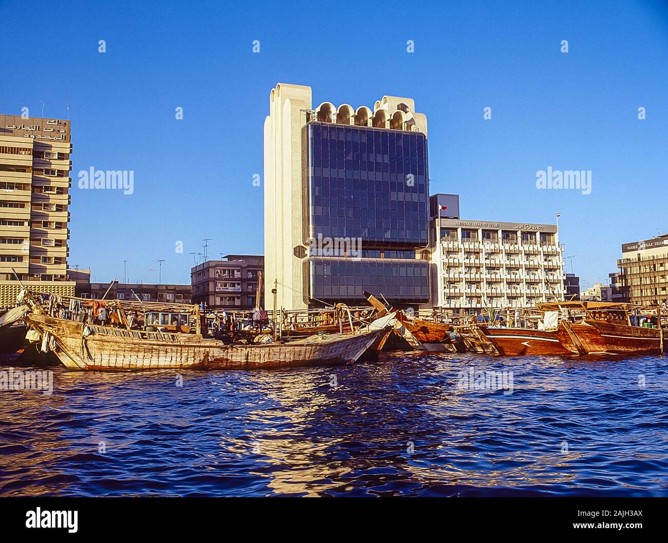 Dubai Creek waterway life and soul of this famous city and worldwide tourist destination with numerous dhows tied up on the quayside from India, Iran and Africa Stock Photo