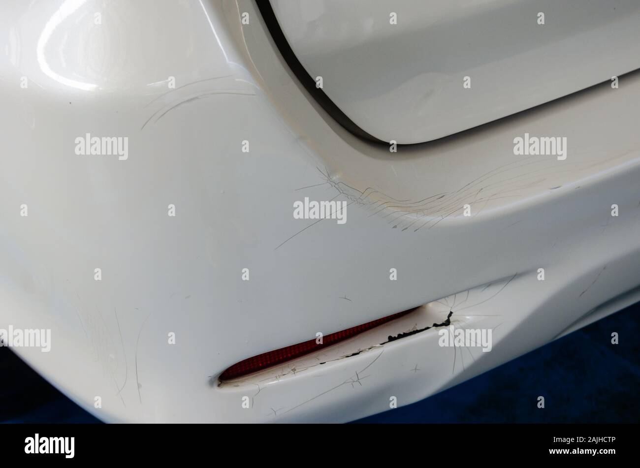 Cracks rear bumper white car. Stock Photo
