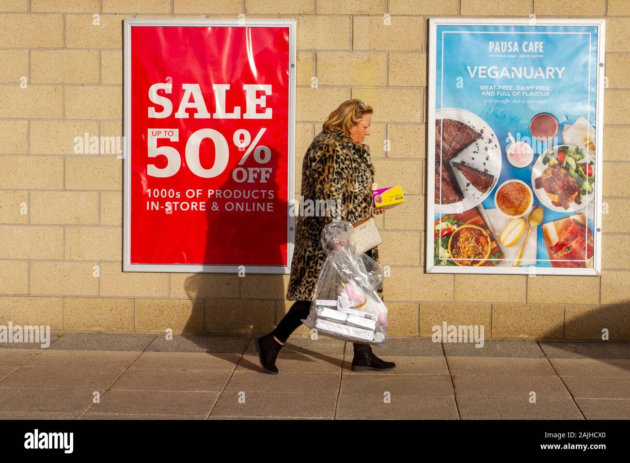 Vegetarianism, vegan, vegetarian, veganism, vegans diet foods;Seafront Retail Park in Southport, UK. January sales under way as shoppers search for bargains. Vegan poster advertises Vegan meals in the Dunelm Pausa cafe. Stock Photo