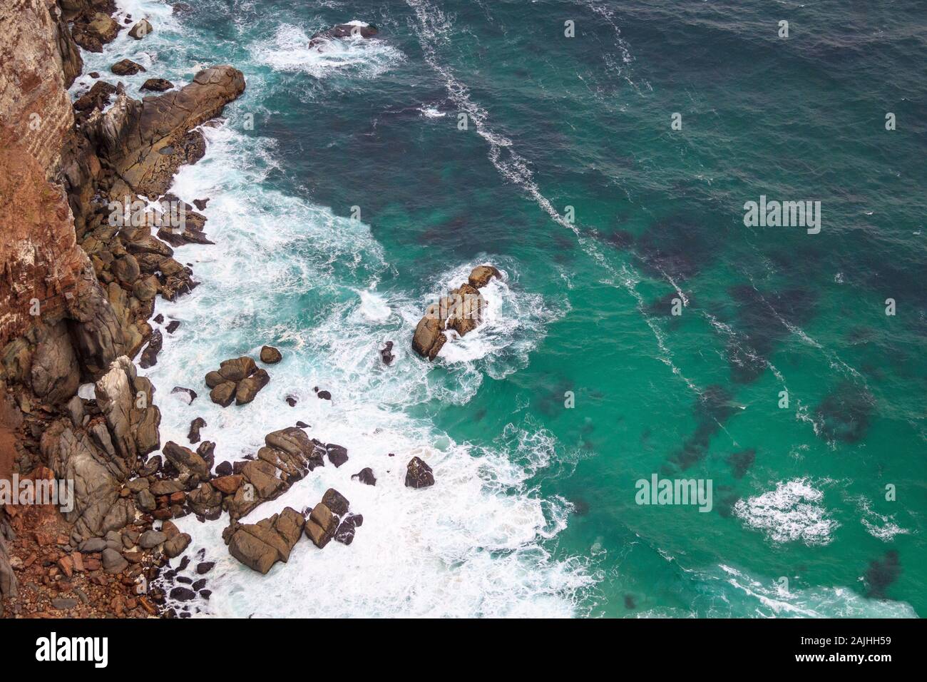 Aerial view of the turquoise sea crashing against steep cliffs, Cape of Good Hope, South Africa Stock Photo