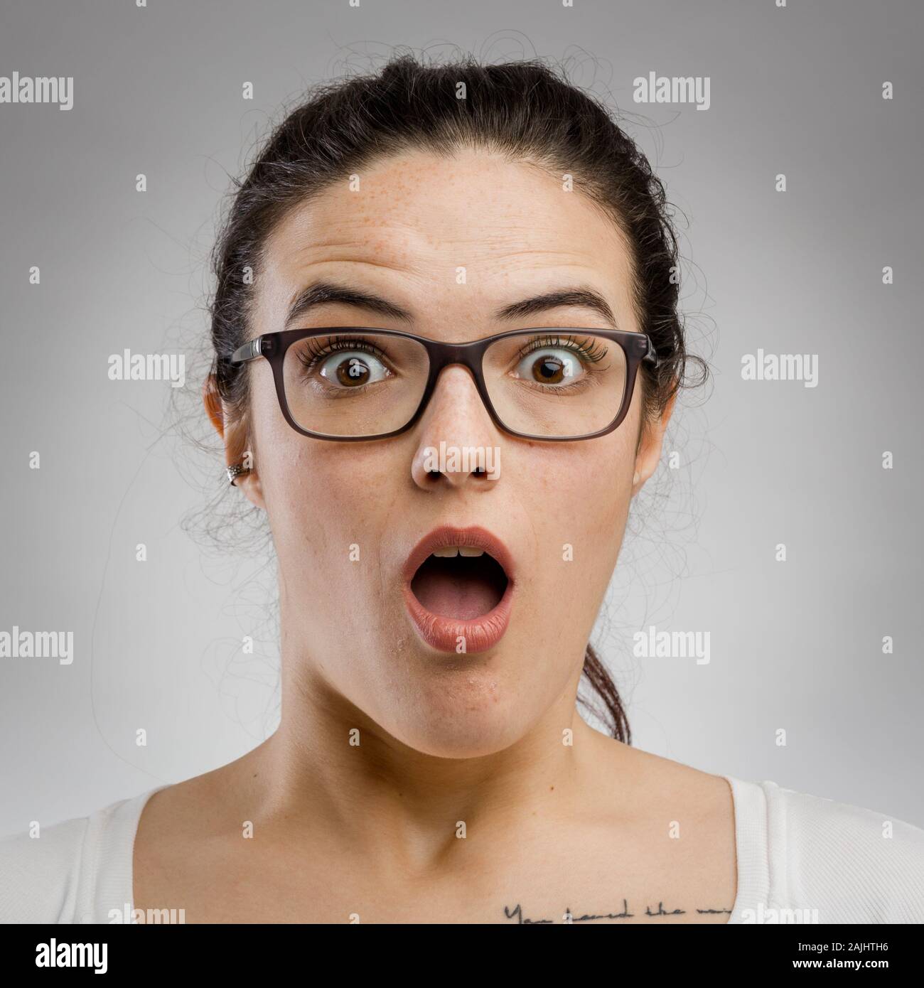 Cute portrait of a woman with a astonished expression Stock Photo - Alamy