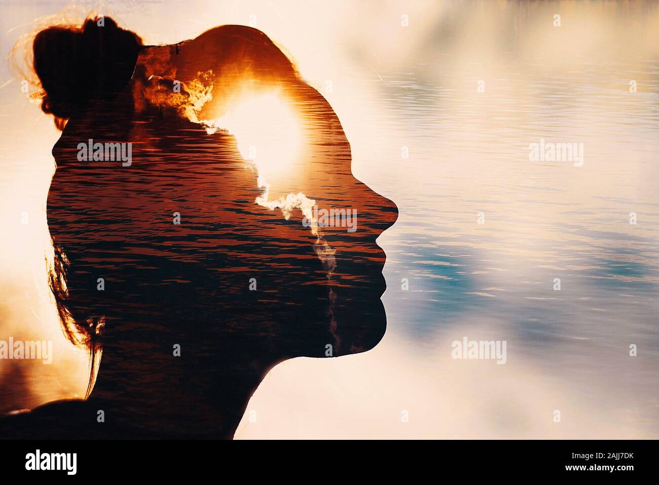 Sun peeks out from behind the clouds in woman's head. Stock Photo