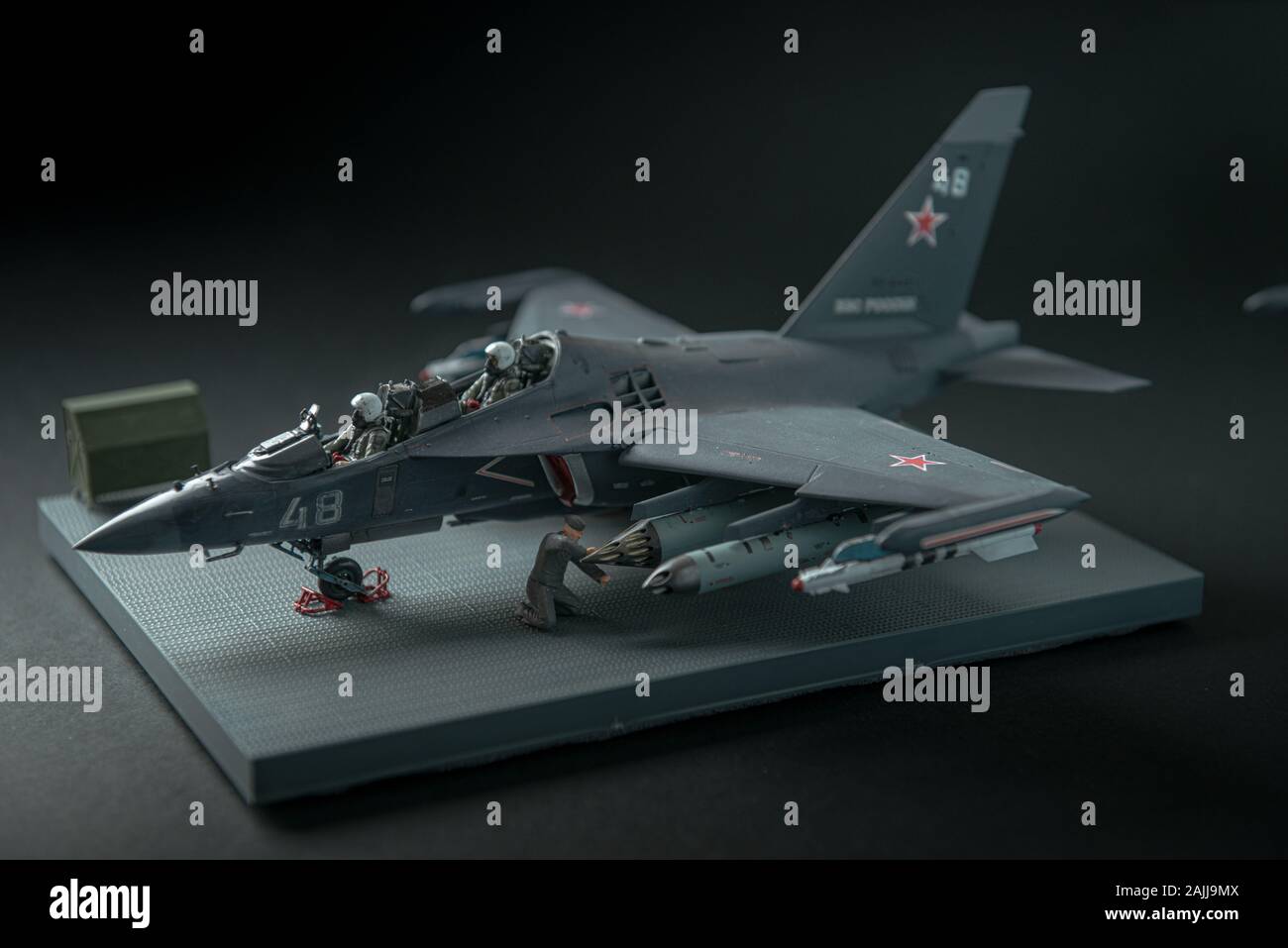 Miniature of military fighter without pilot cabin on a black background with place for text Stock Photo