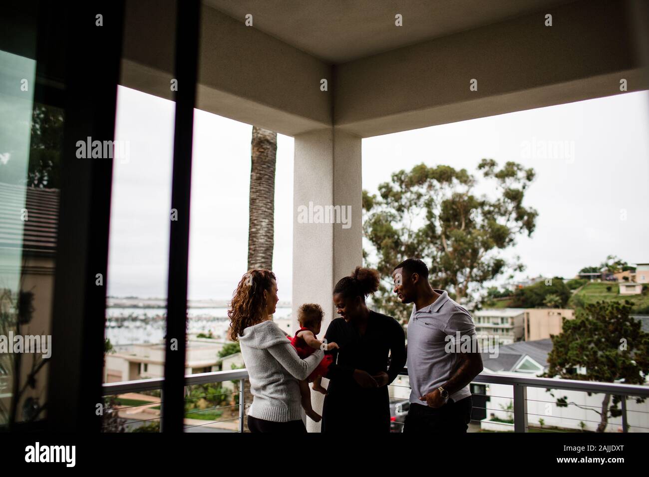 Family standing on balcony hi-res stock photography and images - Alamy