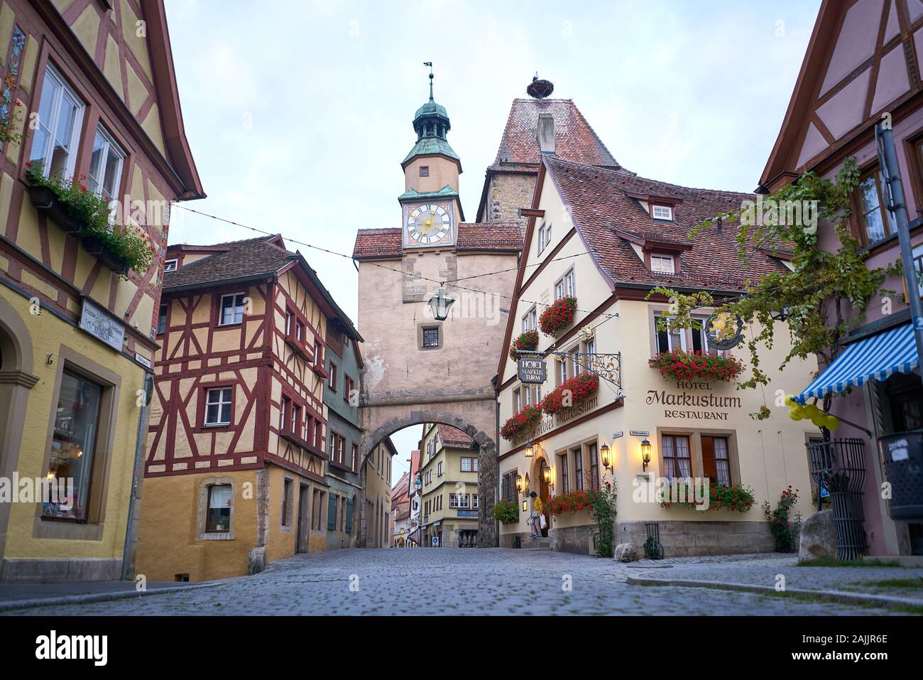 Medieval buildings and clock tower gate at the wall surrounding the old town of Rothenburg, Germany Stock Photo