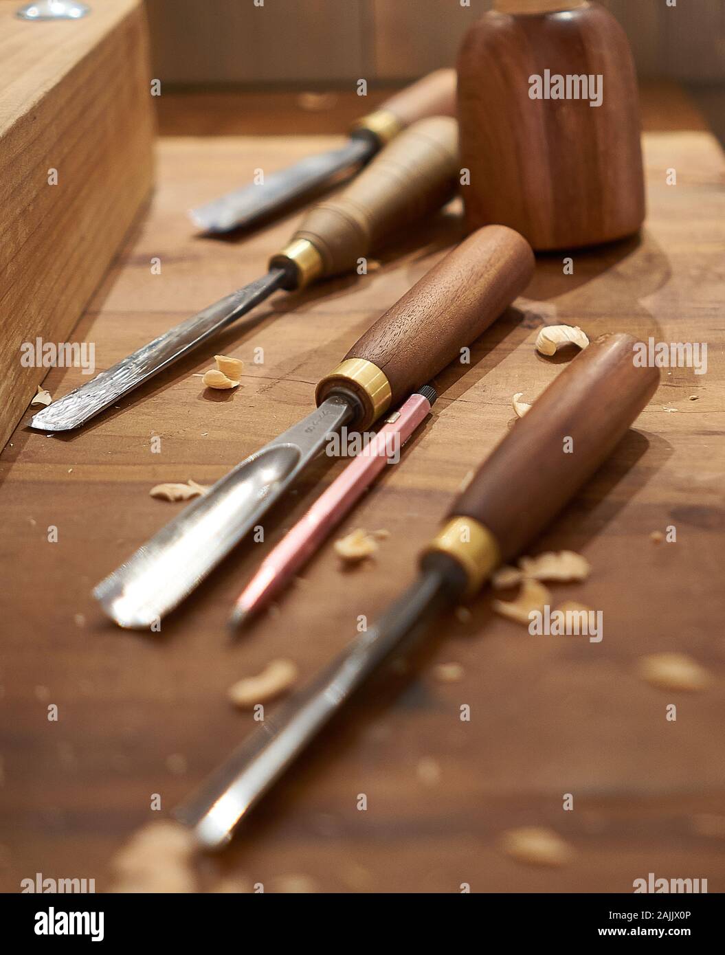 Woodworking tools including chisel and mallet in close up shot with