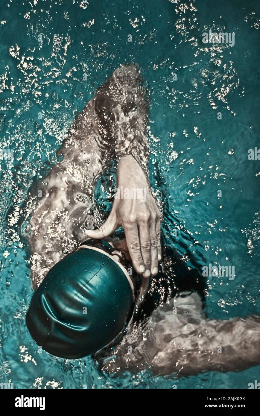 female swimmer with cap in pool Stock Photo