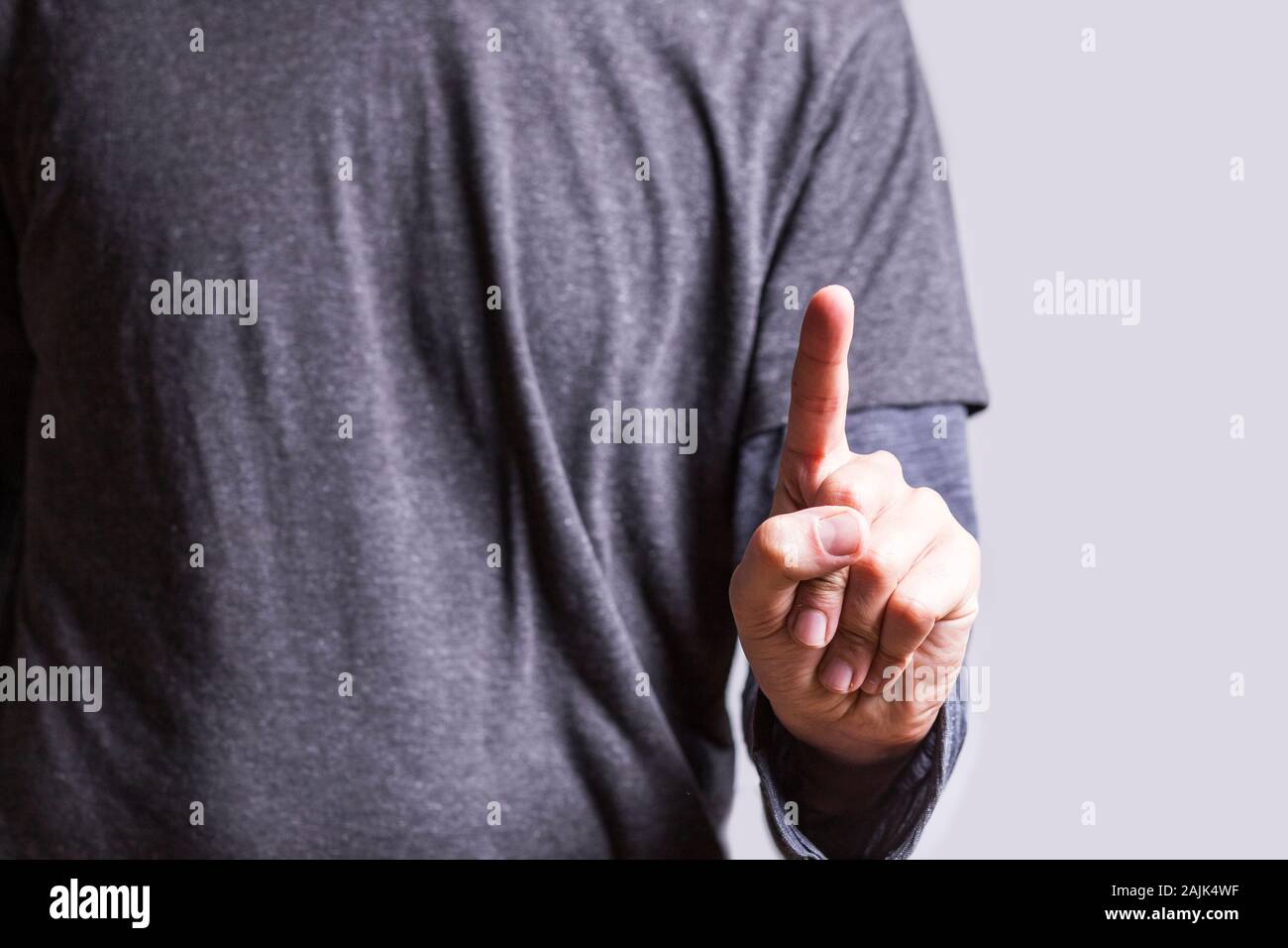 Businessman touching blank virtual screen with his finger - pointing to something or touching a touch screen Stock Photo