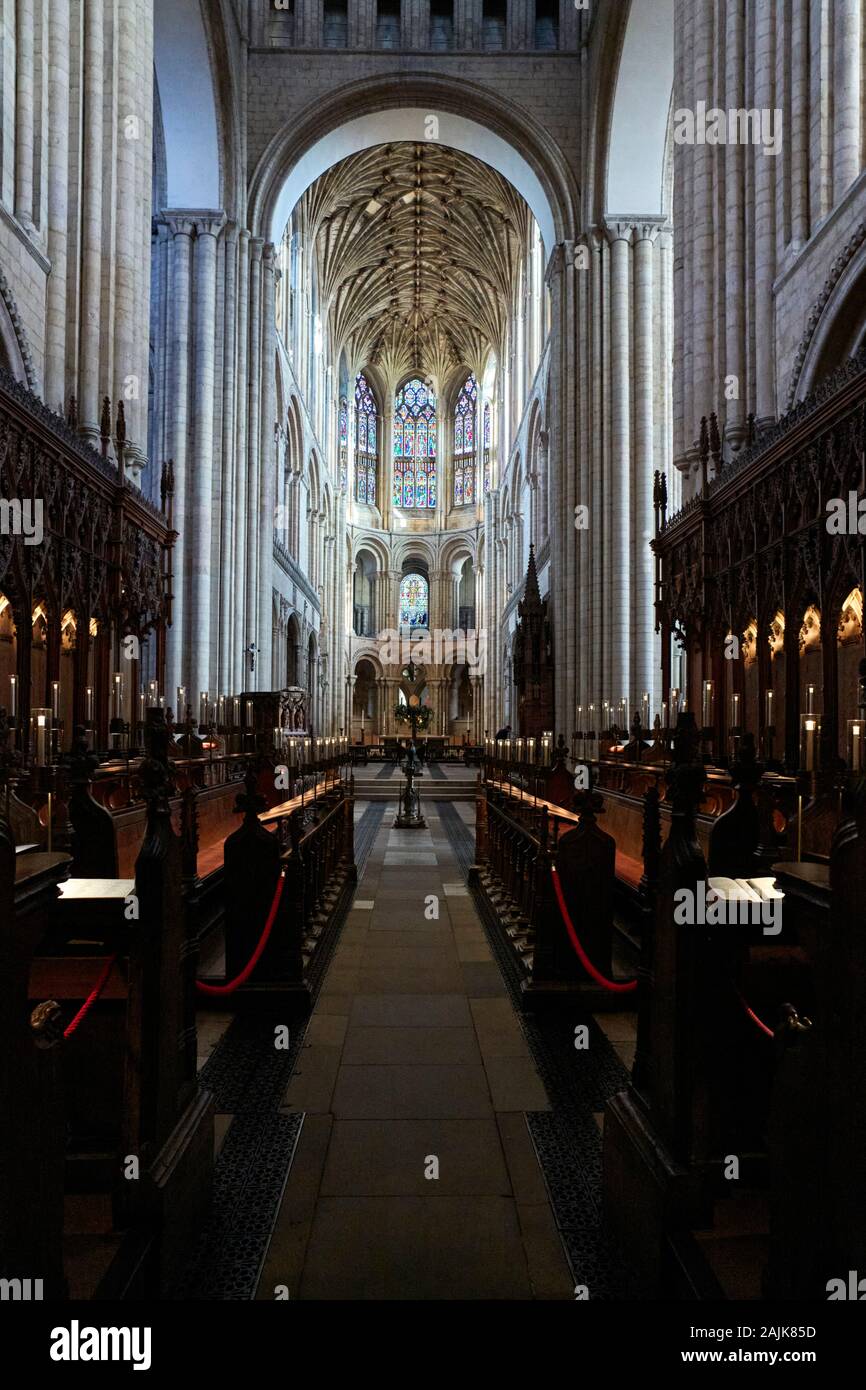 Interior looking towards the altar from the choir stalls with stained glass Stock Photo