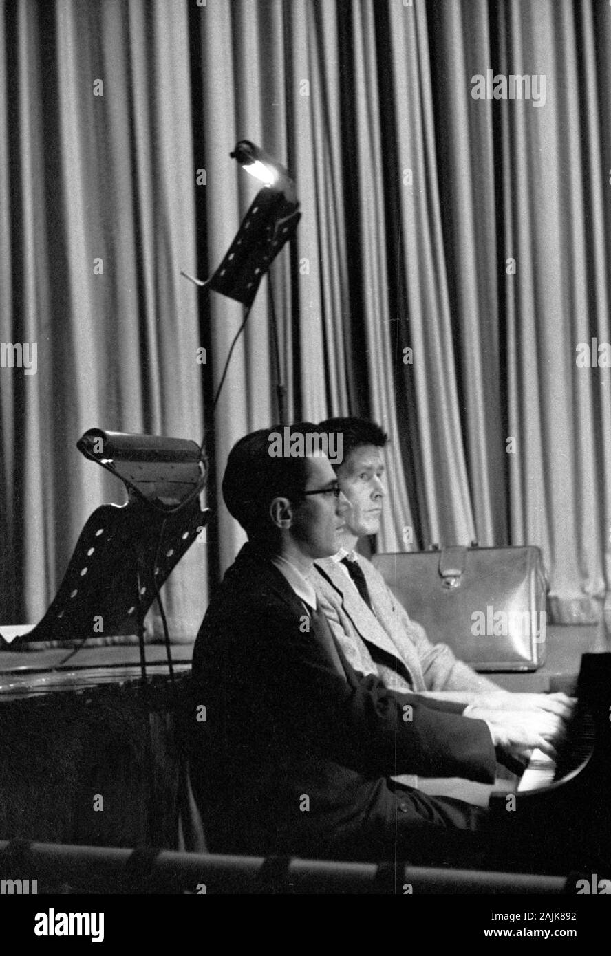John Cage and David Tudor in performance in New York City, 1957, probably performing Winter Music. The exact date and venue are unknown. Stock Photo