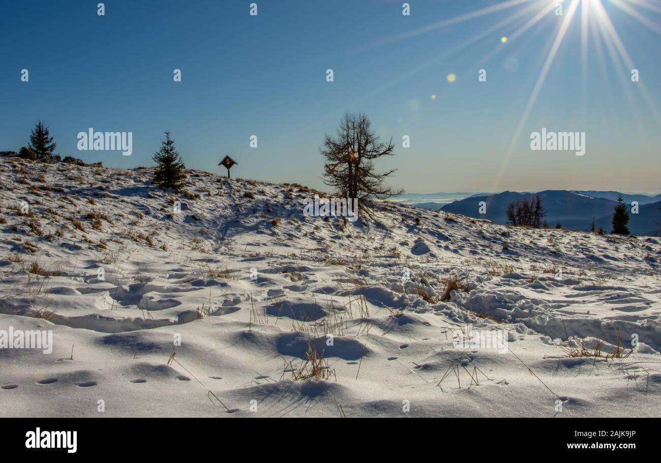 Winter scene high in the mountains. Snowy landscape in peak Uršlja gora, Slovenia. Stock Photo