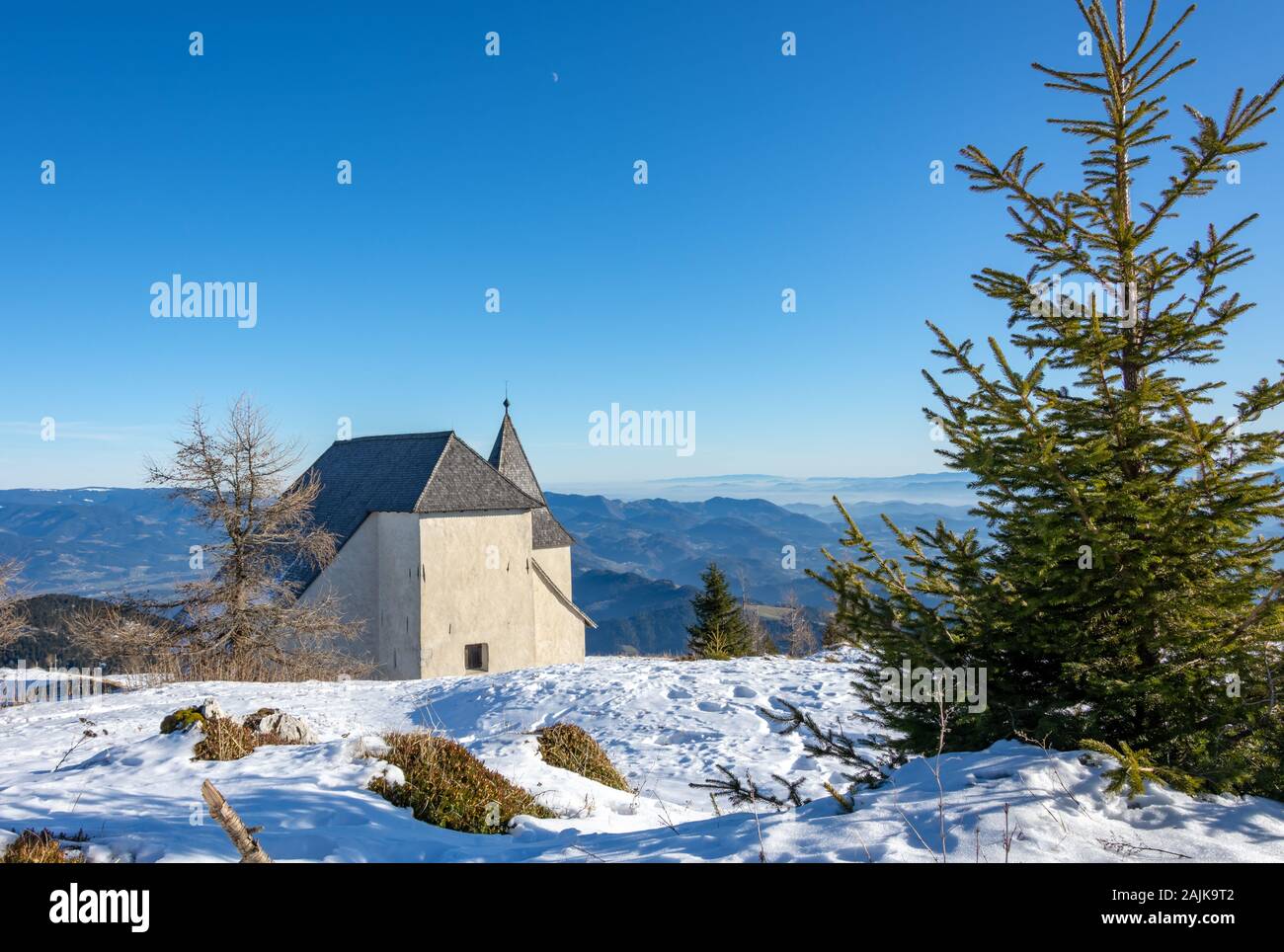 Uršlja gora, Slovenia - January 2, 2020;  Peak Uršlja gora in Slovenia with church St. Uršula. A lonely peak in the heart of Koroška region. Stock Photo