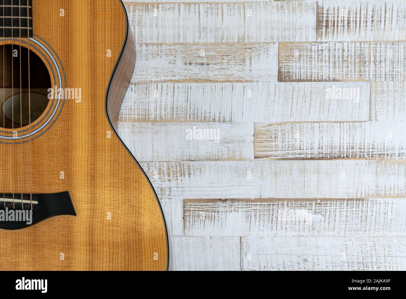 top down view of beautiful acoustic guitar on a rustic white wood background with copy space Stock Photo