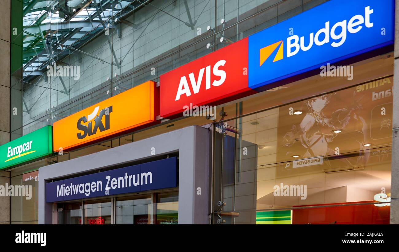 Well known Rental Car company signs outside the Travel Offices of the Cologne Train Station in Germany.  Sixt, Avis, Budget, Eurocar. Stock Photo