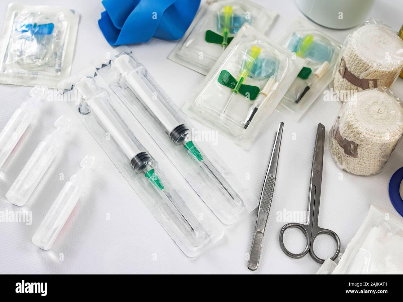 Emergency elements for first aid by the nursing service in a hospital, with  syringes, capsule serum, elastic pressure bands, tweezers and scissors, ba  Stock Photo - Alamy