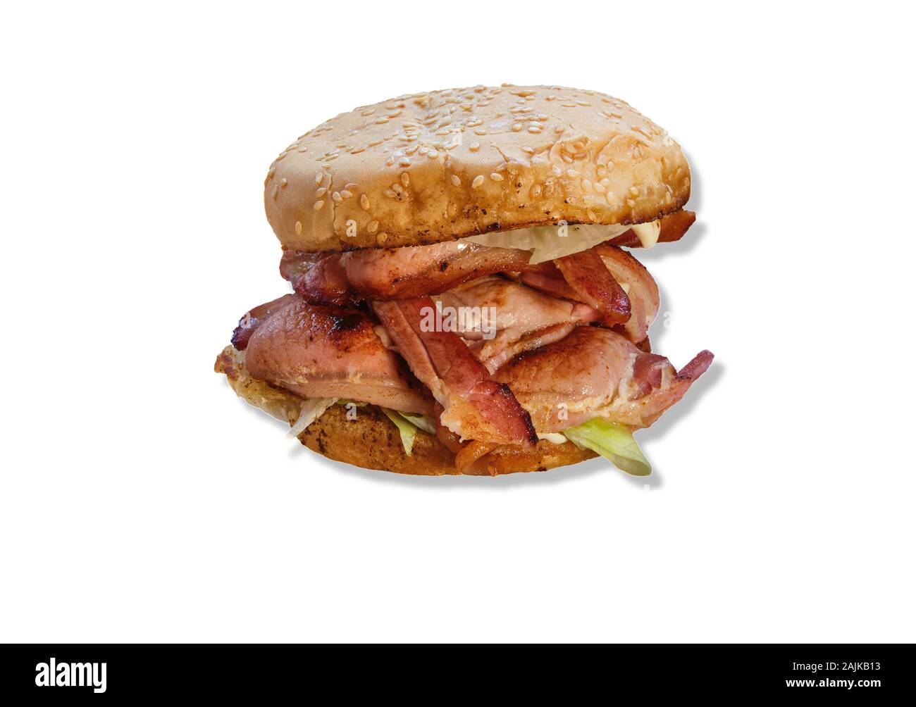 Bacon roll or butty with lettuce in a sesame coated roll or bap. cut out isolated on white background Stock Photo