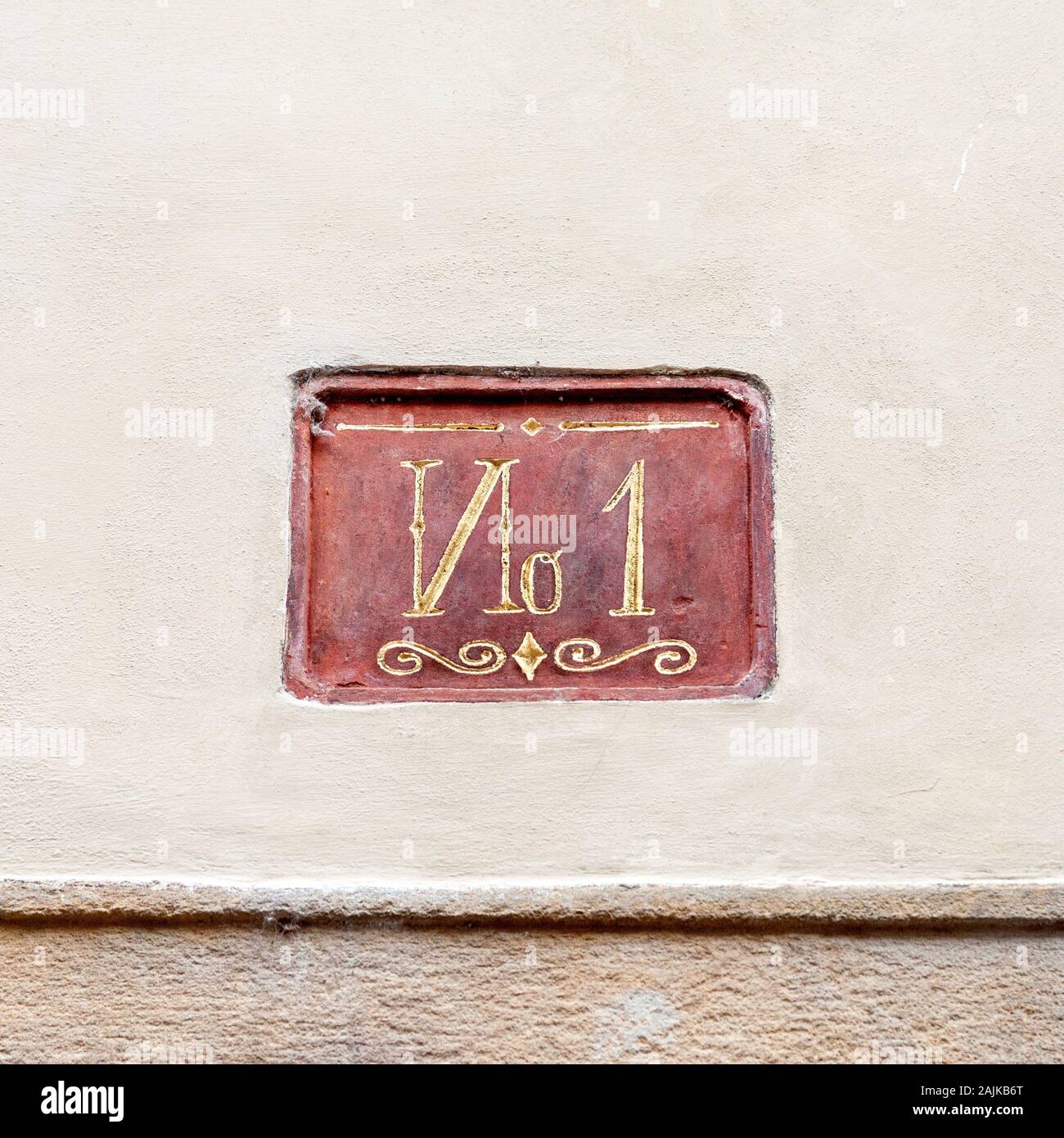 Number one house or apartment plate. Decorative lettering on concrete wall, champion or winner concept Stock Photo
