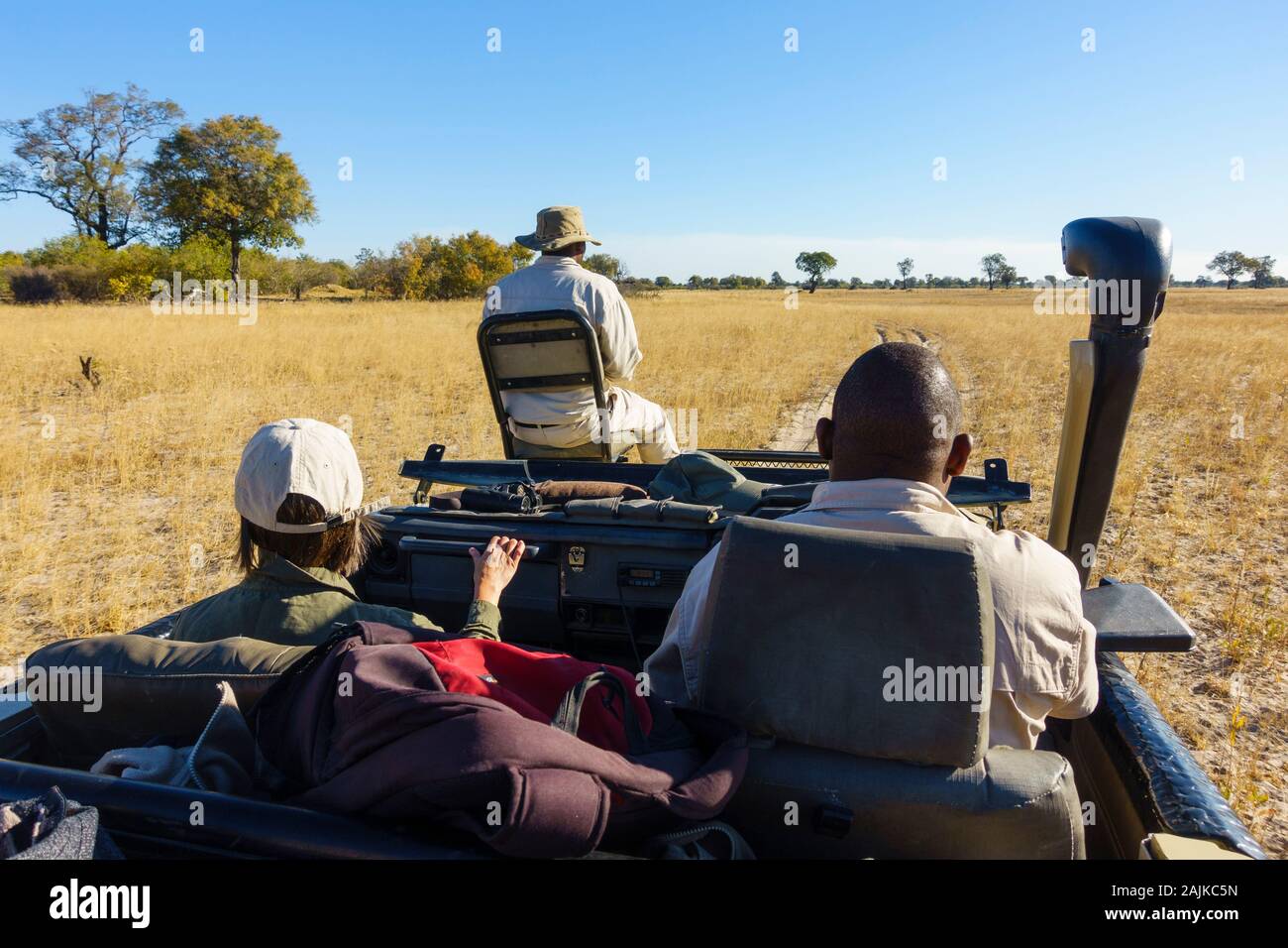 Open topped vehicle safari with driver and guide, Bushman Plains, Okavanago Delta, Botswana Stock Photo