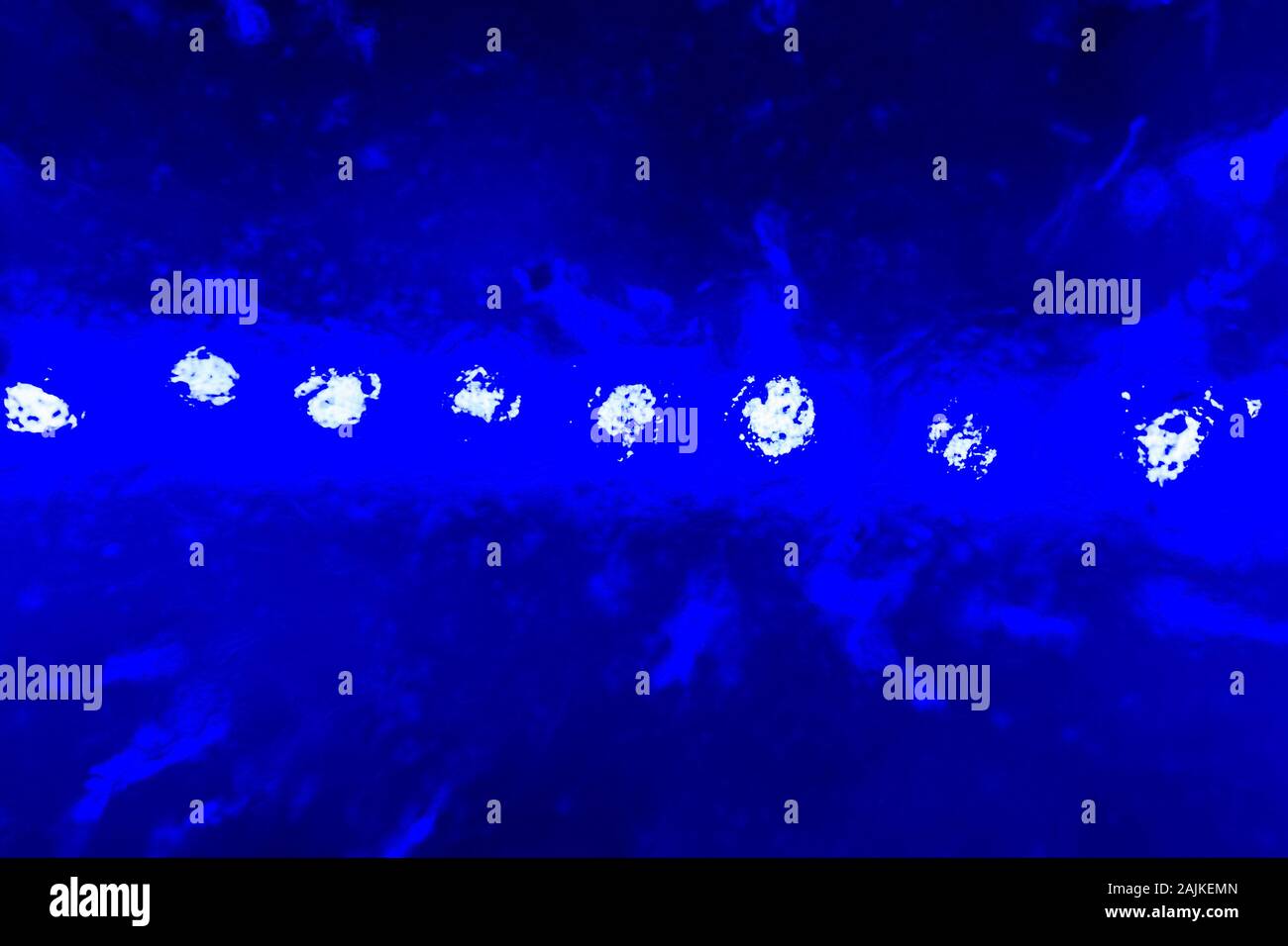 abstract dark blue blurred background - a series of lights shine through ice Stock Photo