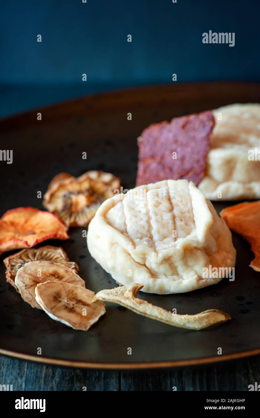 Delicious white soft round cheese with mold with fruit chips. Copy ...