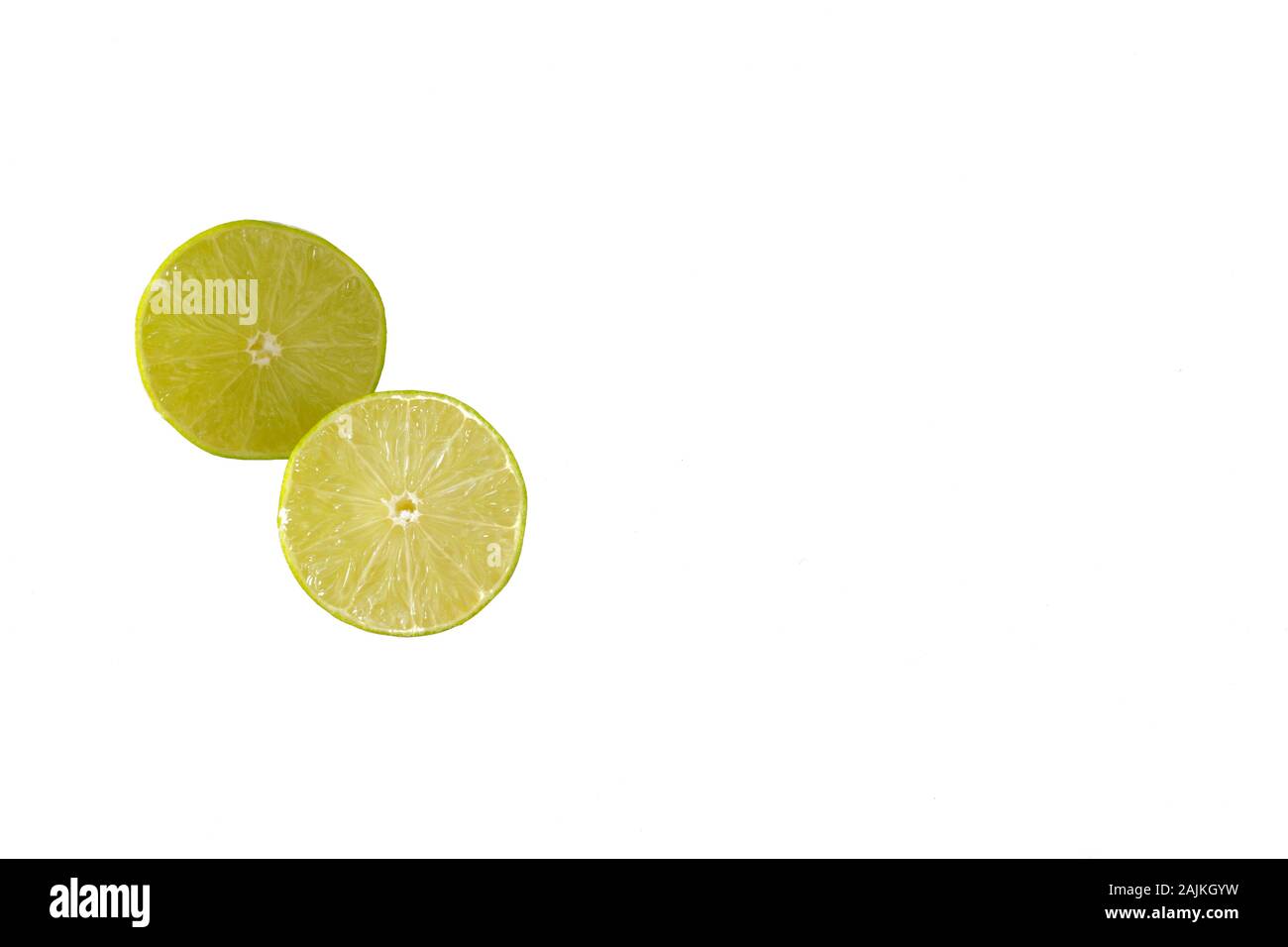 Two lime halves isolated on a white background with copy space to the right Stock Photo