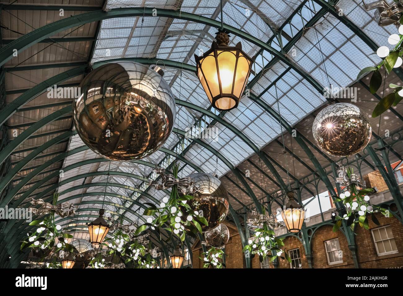 Covent Garden Market Christmas Decorations, decorative baubles, holly  and decor in roof structure, London Stock Photo