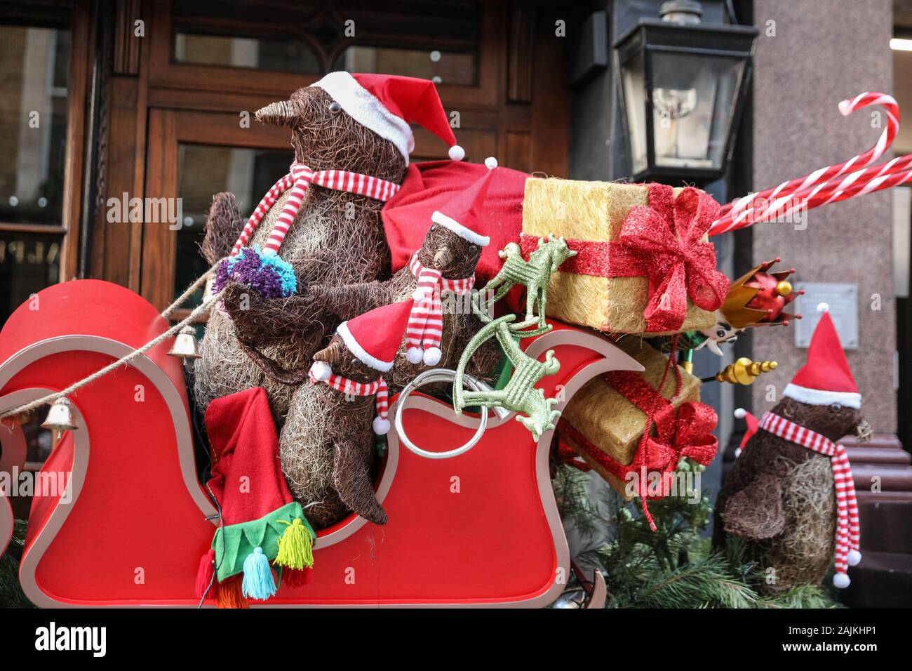 Christmas decorations in London, exterior, display of santa penguins and presents, UK Stock Photo