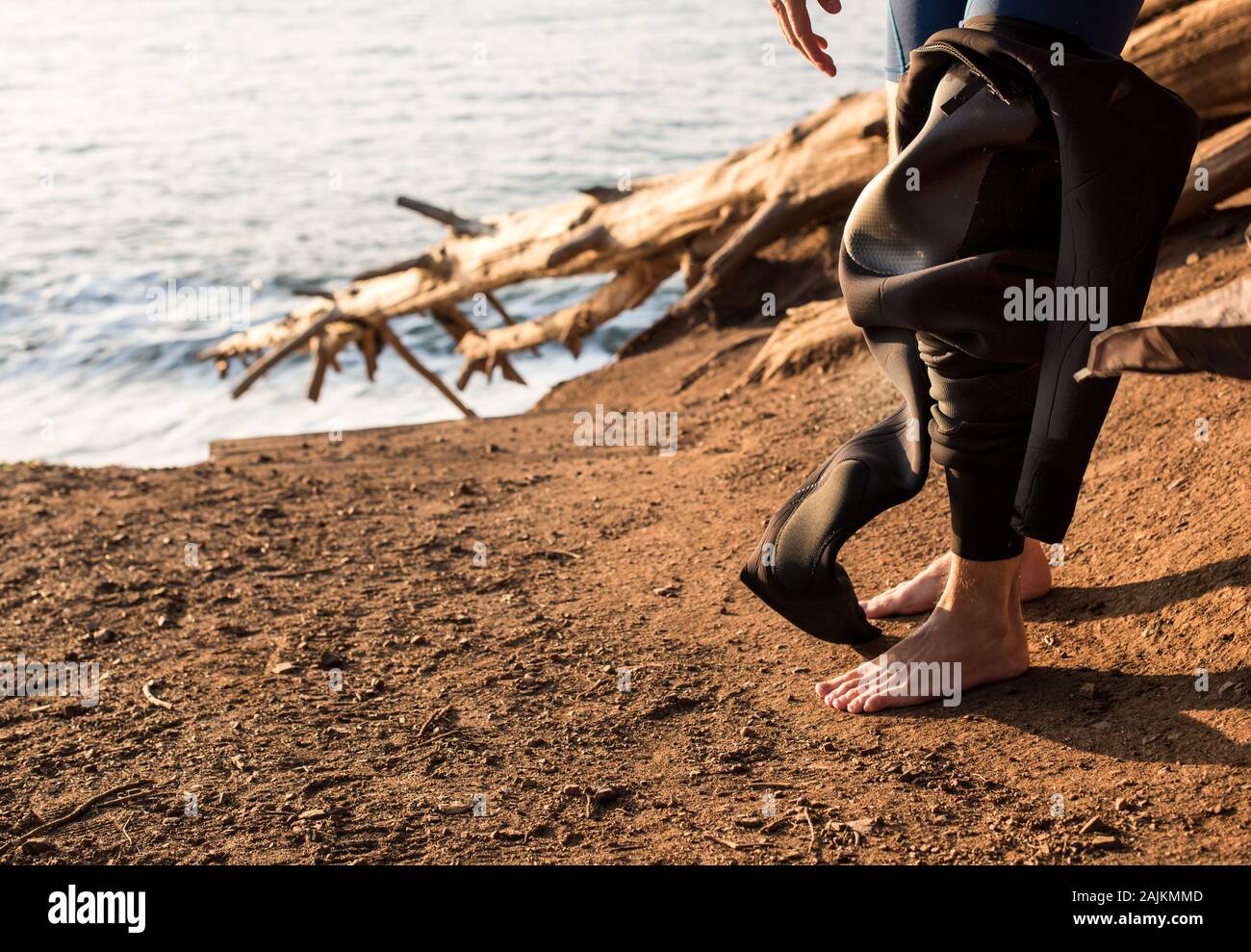 men putting on wetsuit in California Stock Photo Alamy