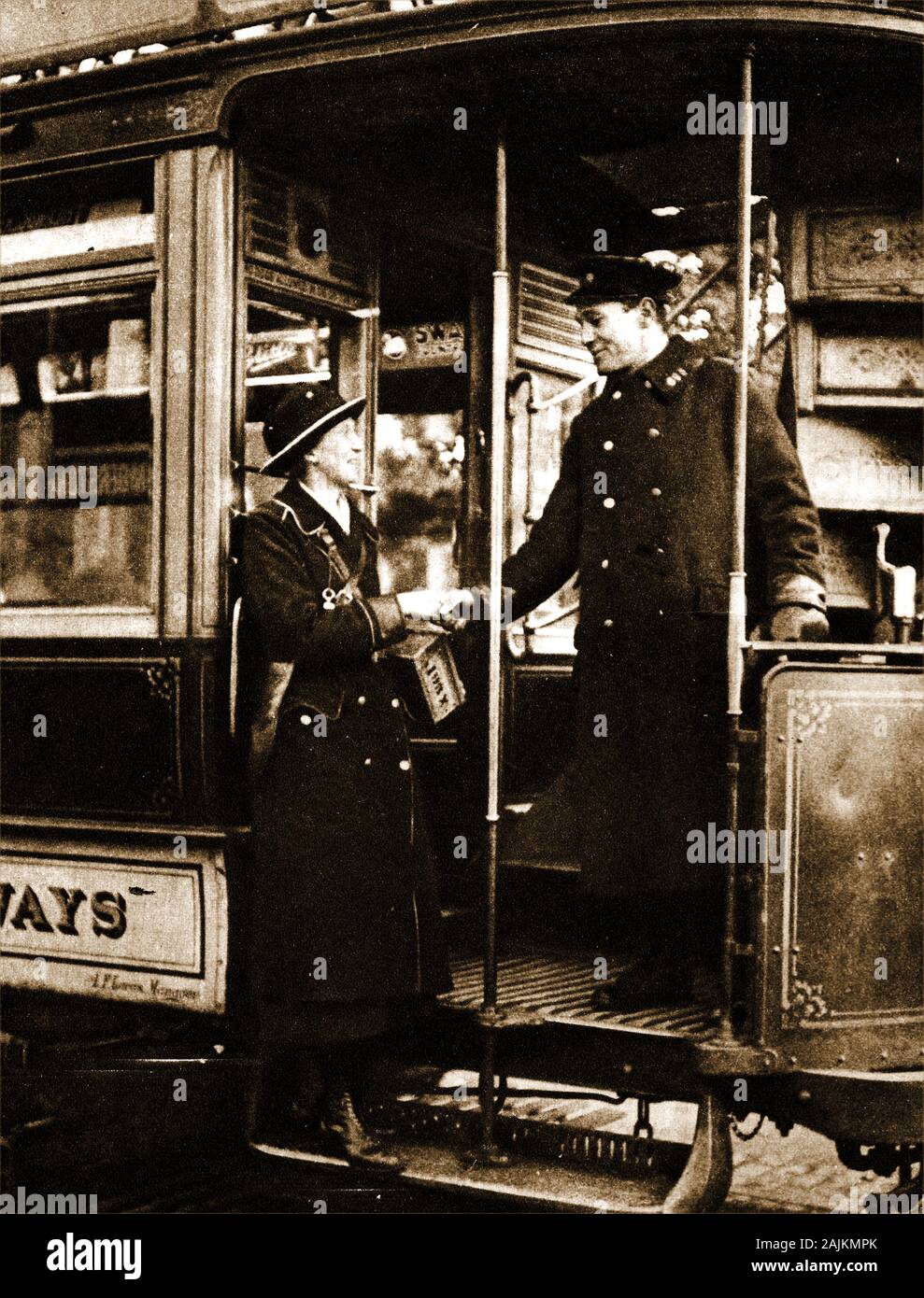 1919 -  British Women who worked in men's jobs during WWI began to hand back their positions to men. Here are a woman conductress and a male bus conductor in the process of handing over. (During WWI over 6 million men enlisted to  fight overseas, leaving their positions vacant. Women took over their previously 'male only' positions). Paid less than men, many soon came out on strike. Stock Photo