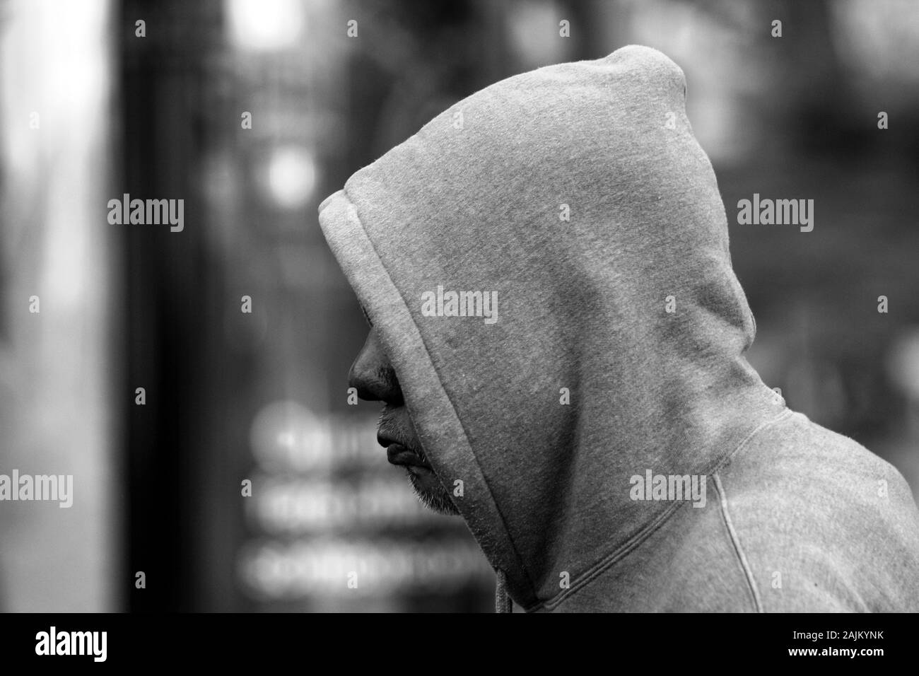Man wearing a hoodie with hood pulled up Stock Photo