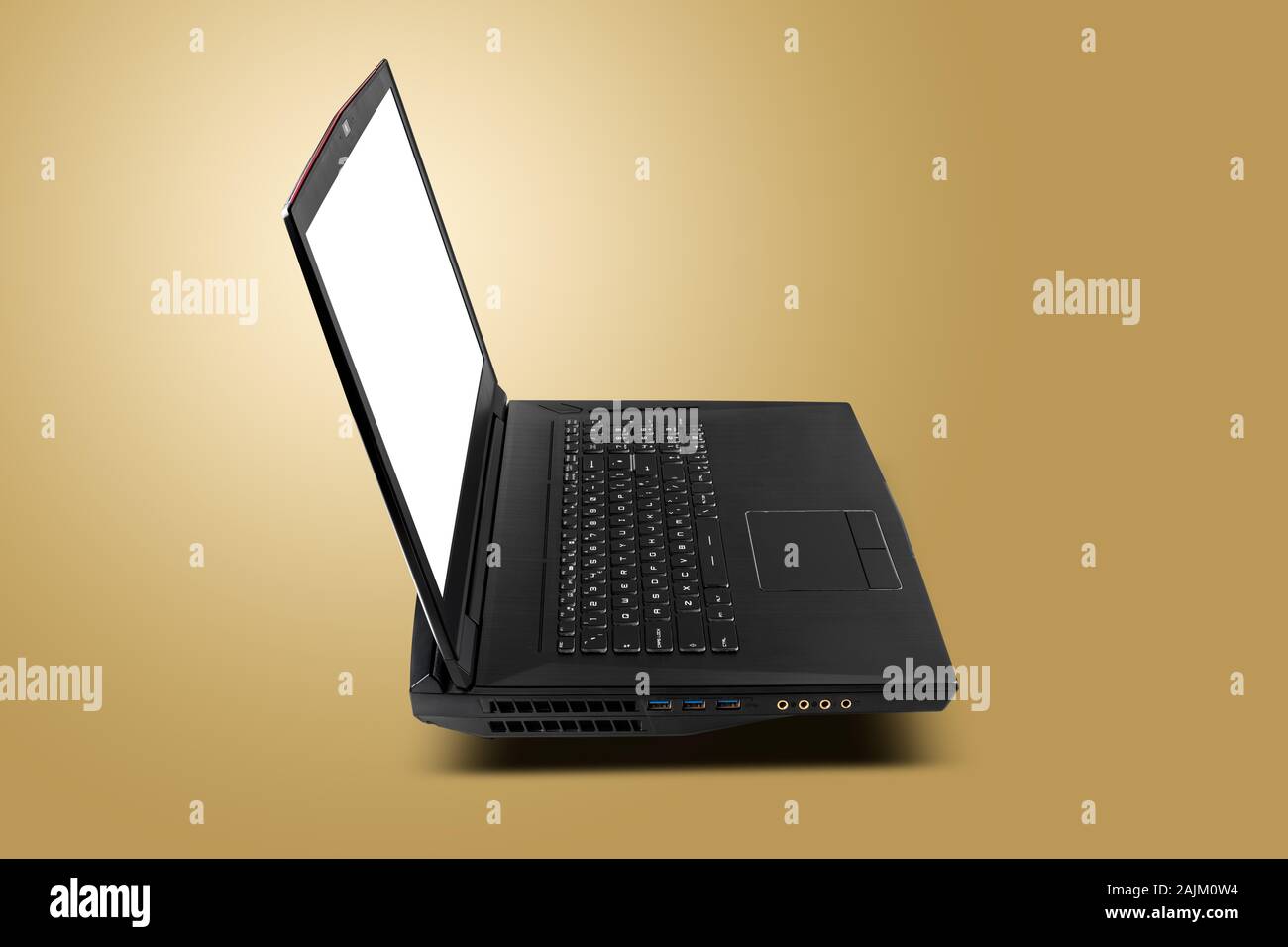 Side view of gaming laptop on golden yellow background. Laptop designed for gamers or professional players or 3d rendering Stock Photo