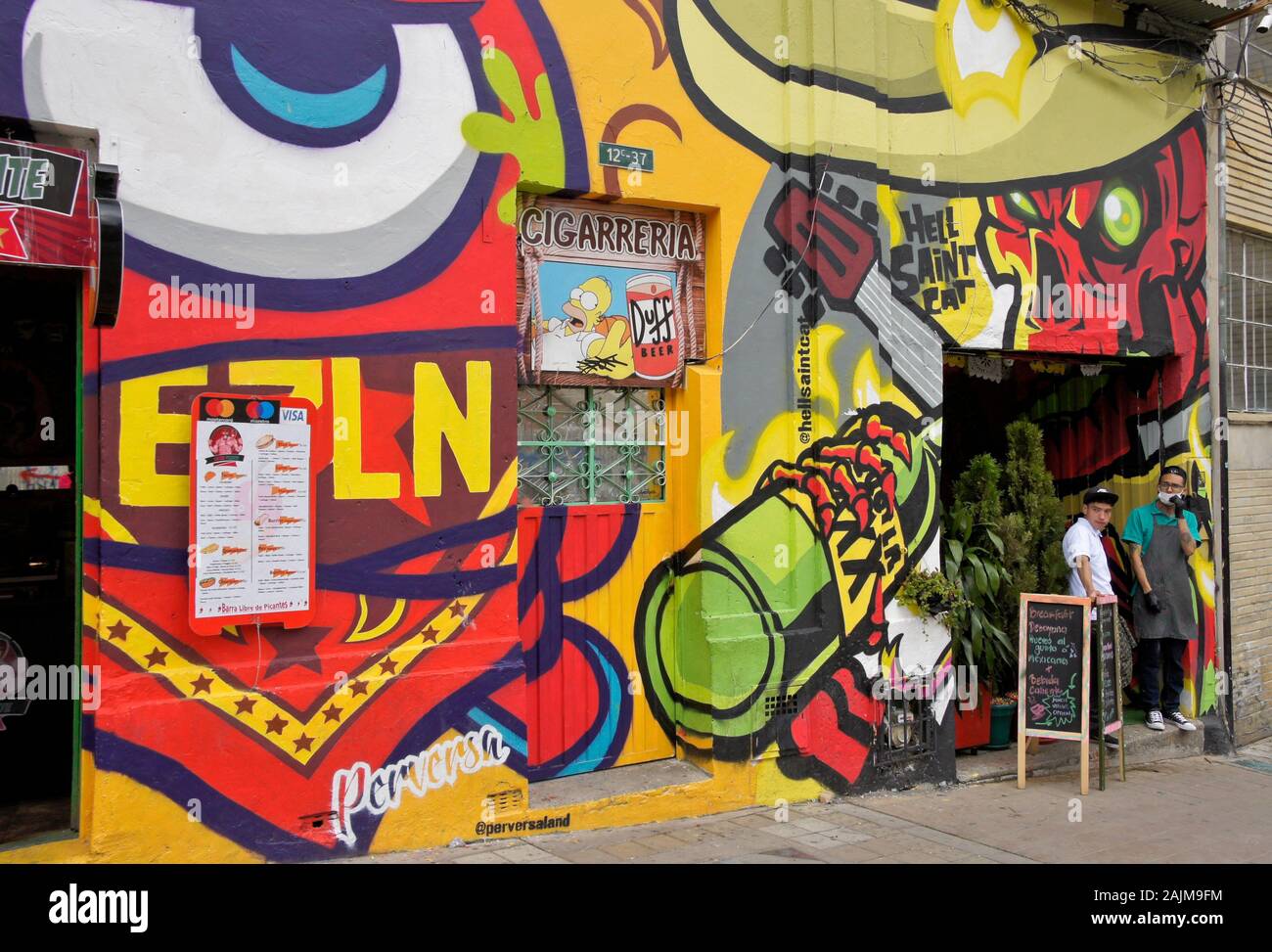 Colorful street art painted by Perversa and Hell Saint Cat on exterior of eateries in La Candelaria district of Bogota, Colombia Stock Photo