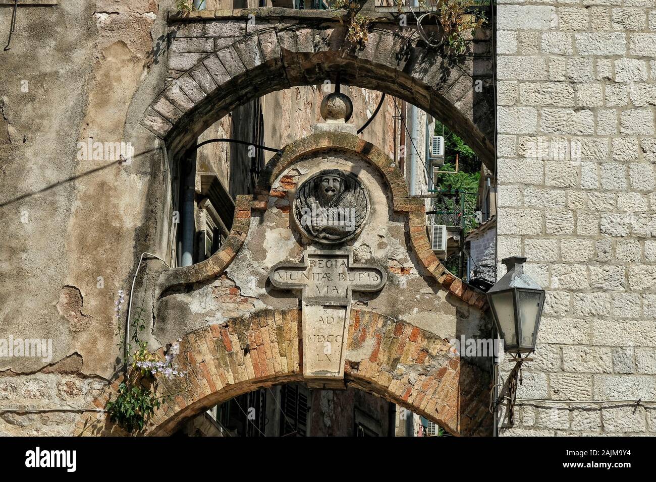 Kotor, Montenegro - June 2019: Street leading to the main entrance of St. John's fortress with the emblem is the Venetian lion on June 21, 2019. Stock Photo
