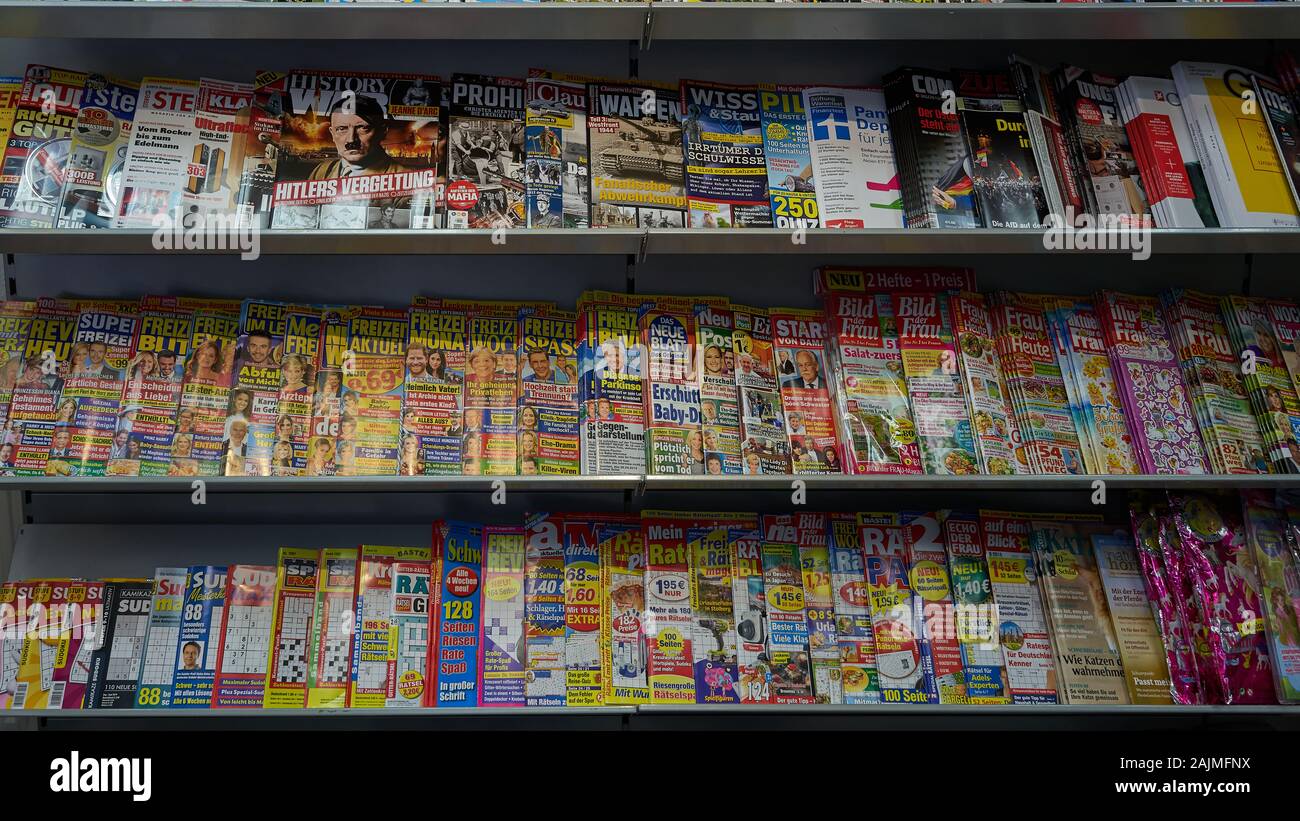 Magazine rack full of colorful publications and tabloids on a variety ...