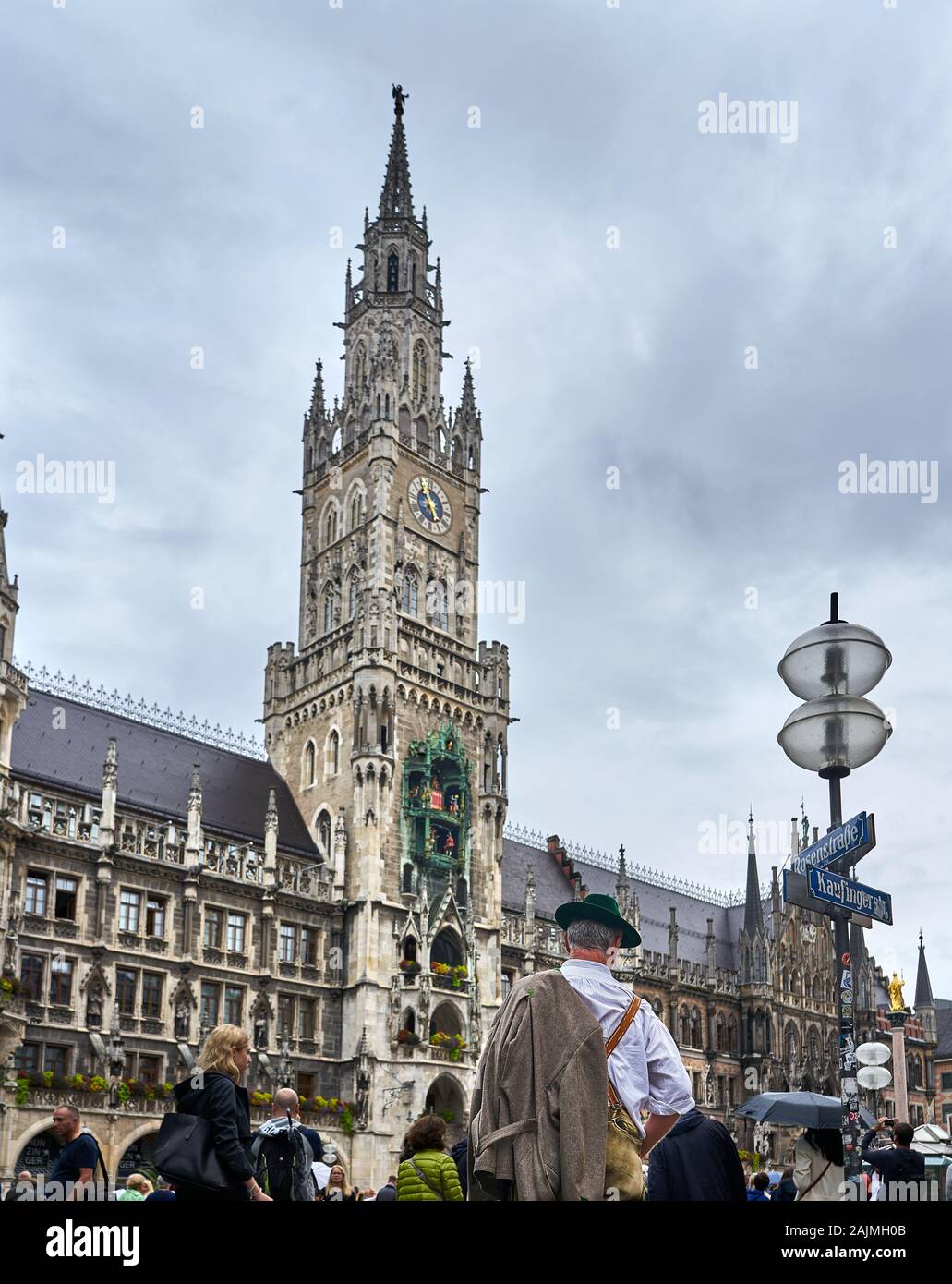 Man dressed in traditional Bavarian outfit watches the famous Rathaus Glockenspiel in Marienplatz, Munich, Germany. Stock Photo