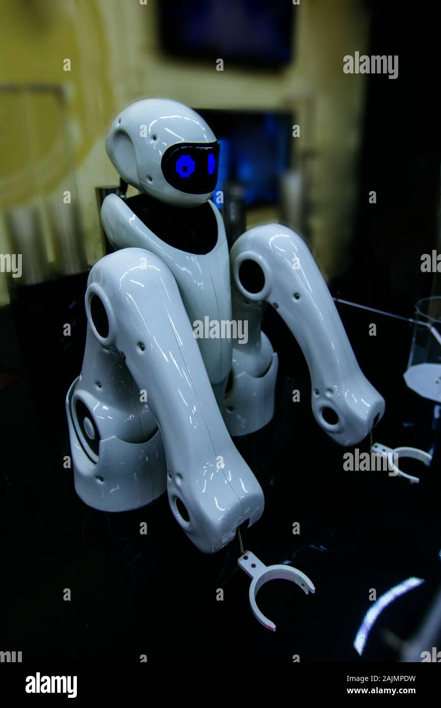 Robot with mechanical arms in beer bar pub. Stock Photo