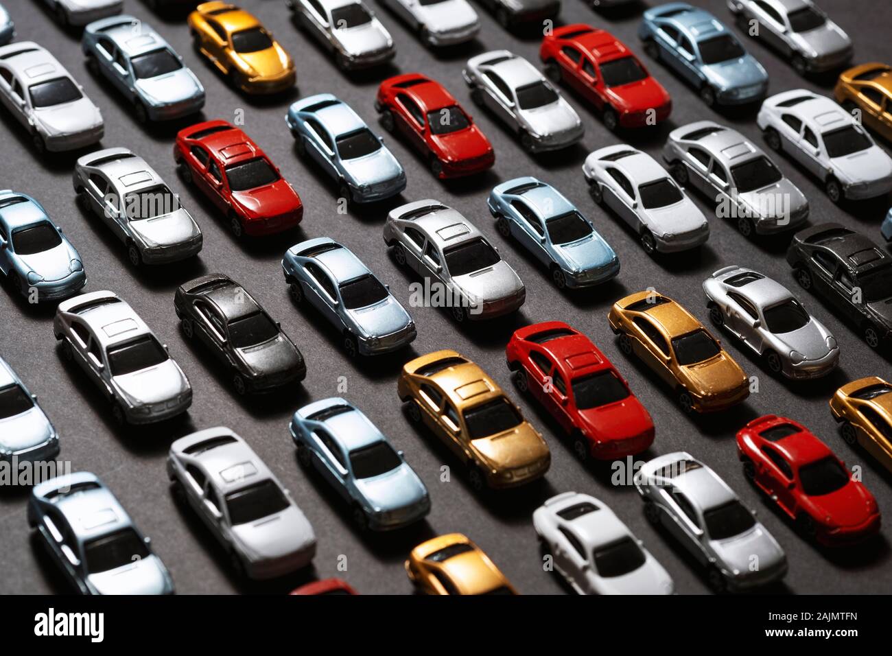Top view of Parked toy cars on a black background like a car parking