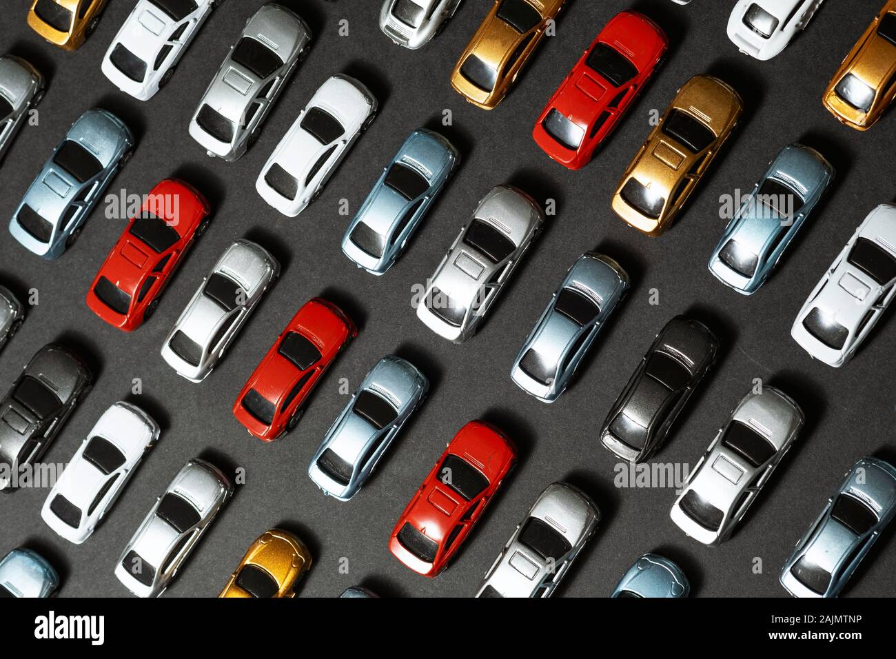 Top view of Parked toy cars on a black background like a car parking lot. Stock Photo