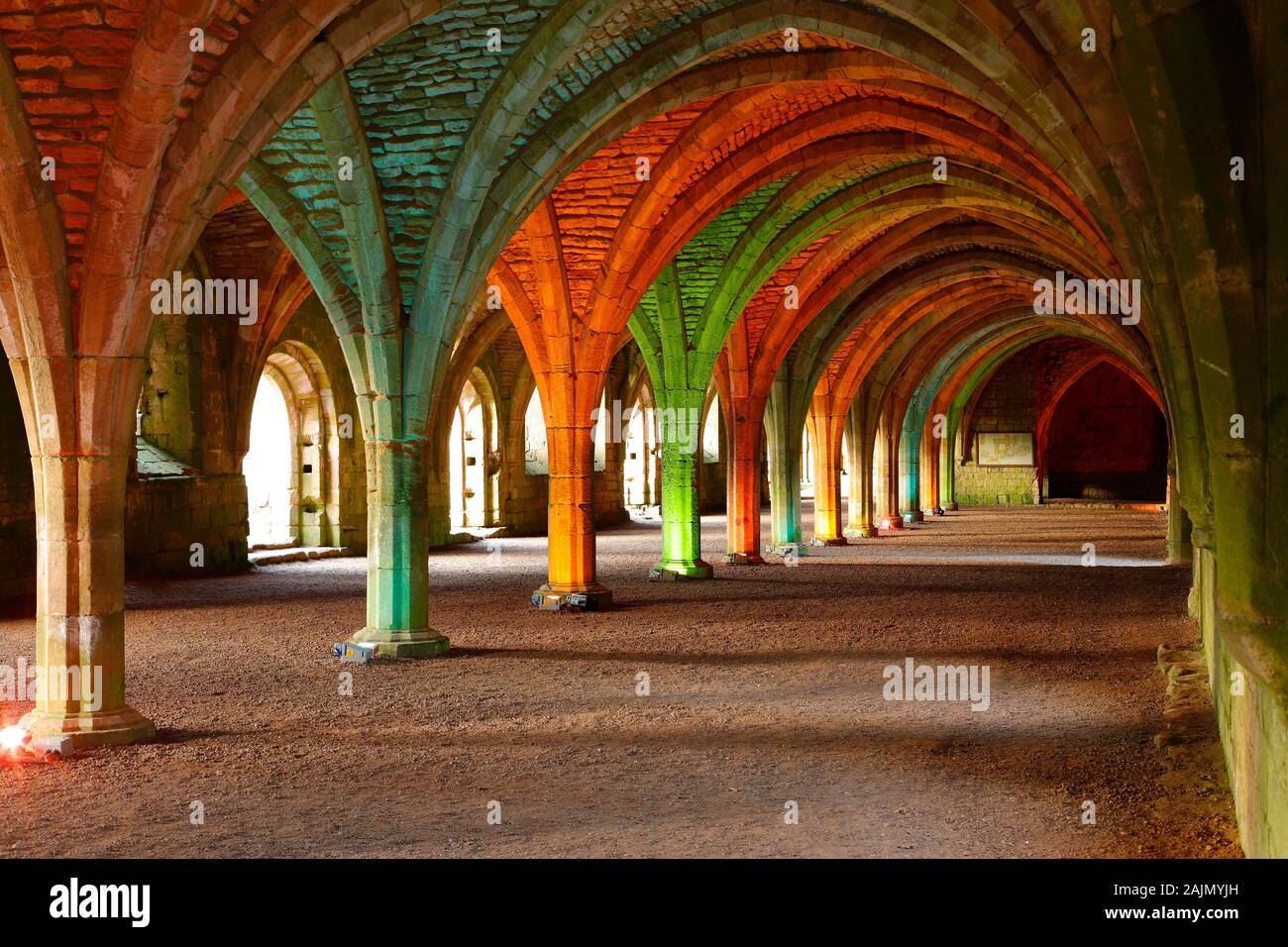 The Cloisters at Fountains Abbey during a Christmas coloured illumination event. Stock Photo
