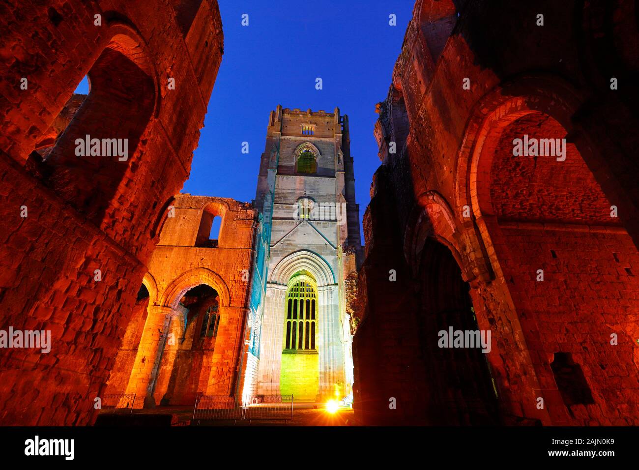 Fountains Abbey Tower at night, during Christmas coloured illuminations Stock Photo