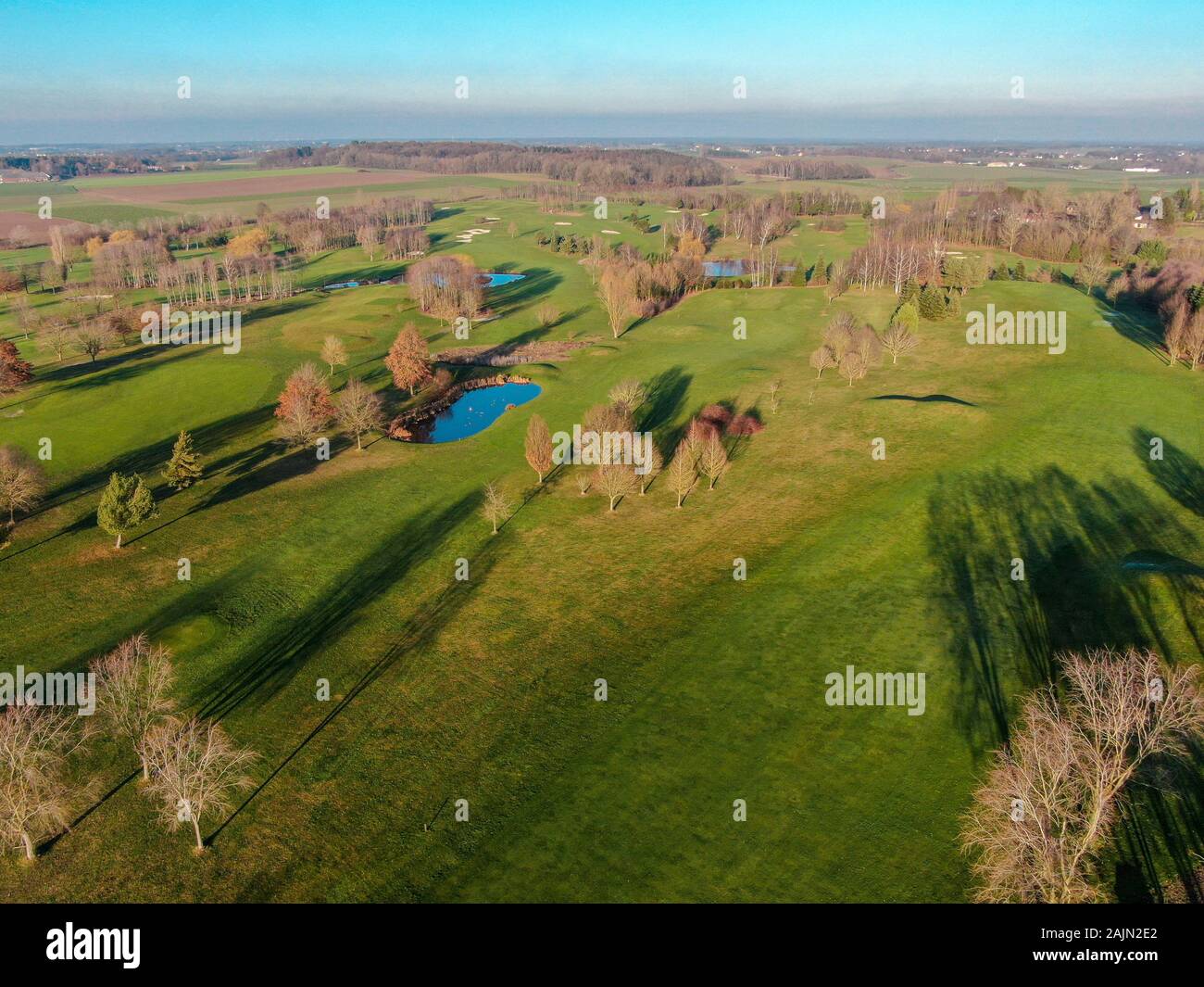 Aerial view of a golf course. Colorful trees and green course during autumn season in the South of Belgium, Walloon Brabant. Stock Photo